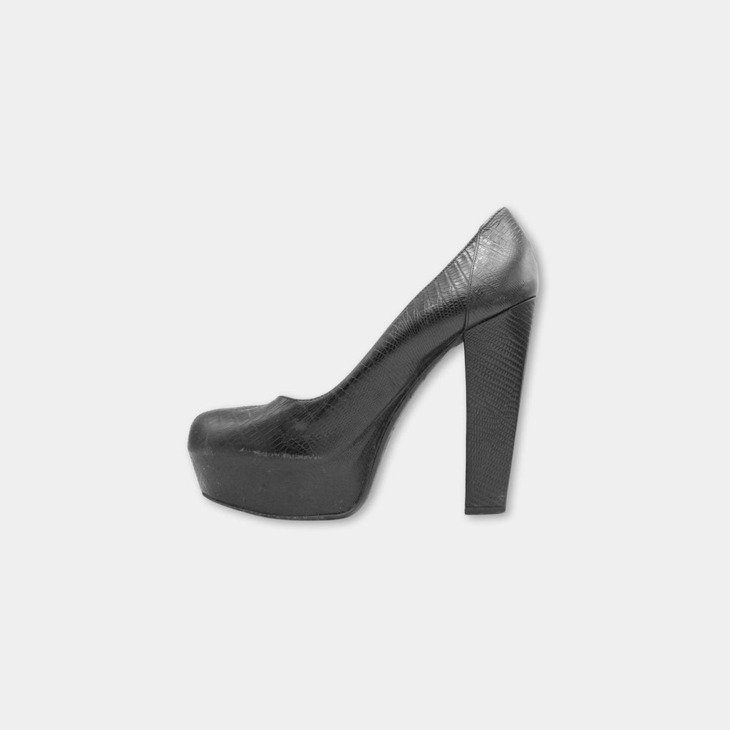 A single black high-heeled shoe against a white background.