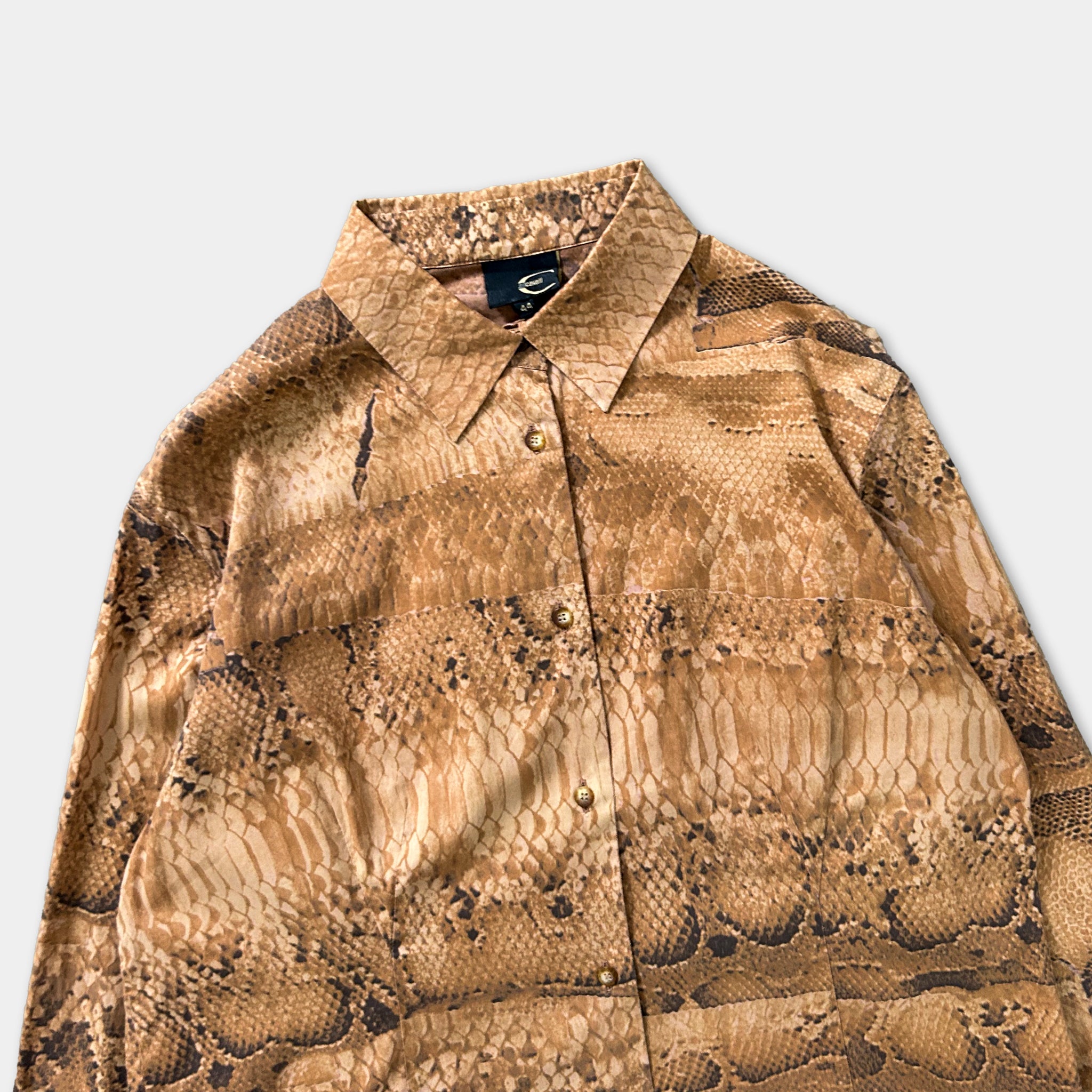 a brown, patterned shirt with a distinctive snake skin design.