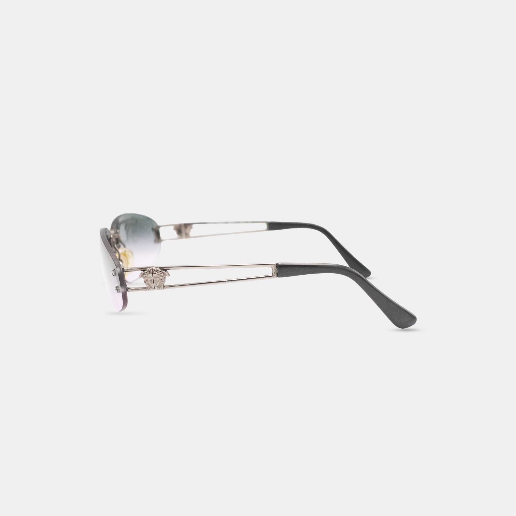 A pair of sunglasses with a silver frame and black arms, featuring a distinctive design element.