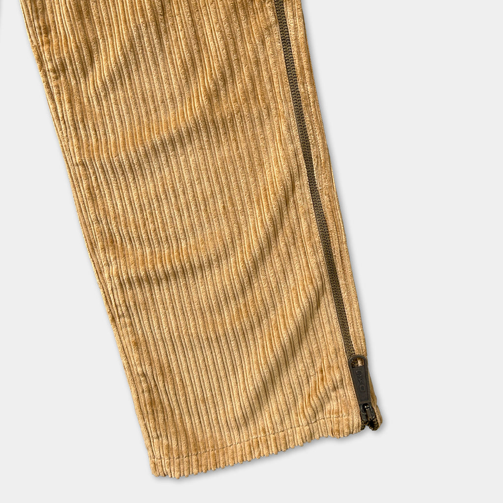 a close-up view of a pair of corduroy pants with a zipper running down the side.