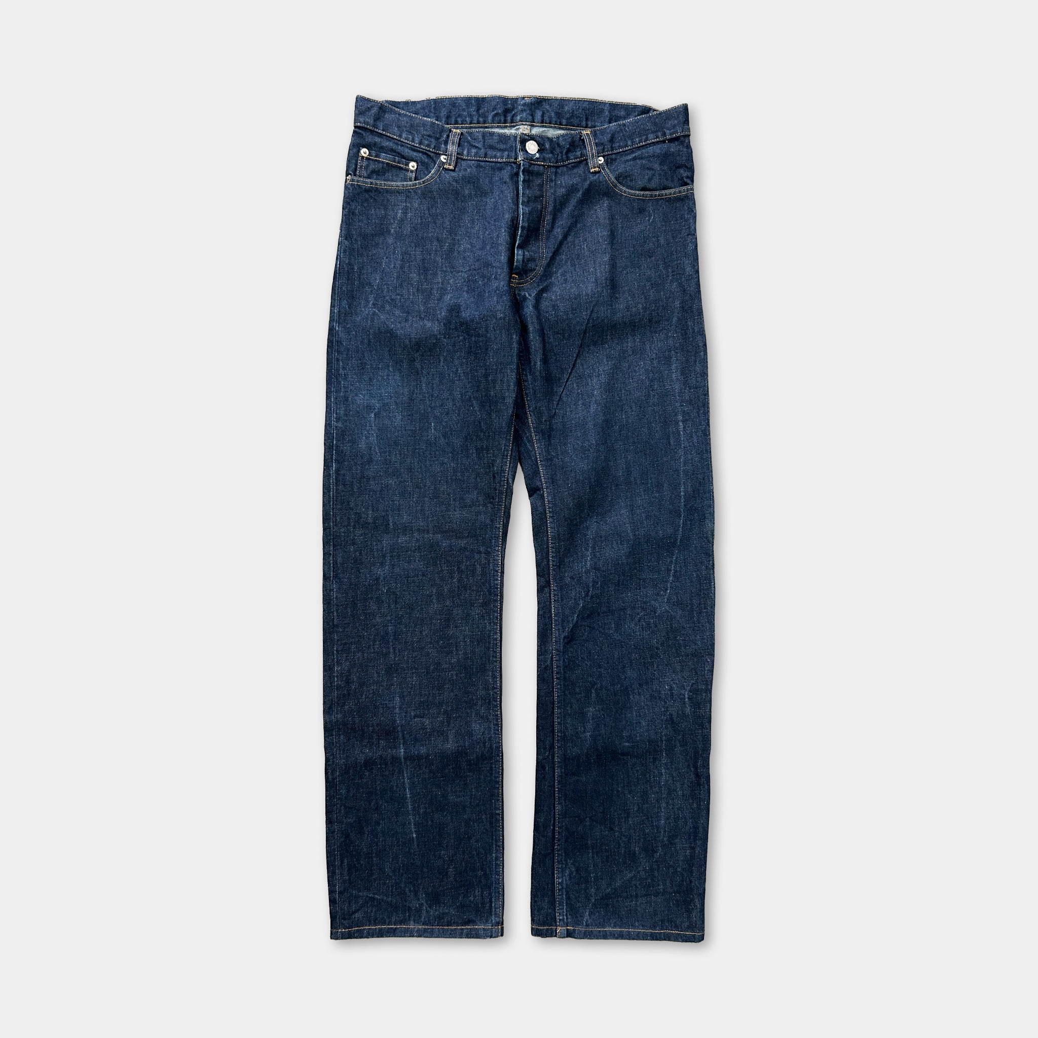 A pair of blue denim jeans with a button closure and a pocket on the front.