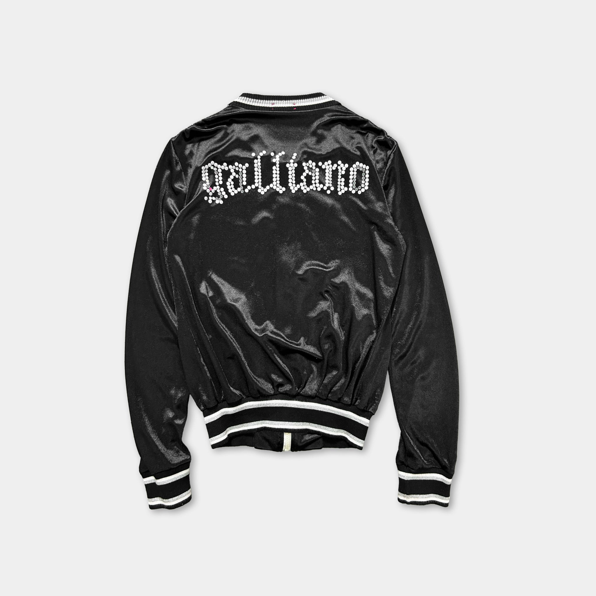 A black satin jacket with white text on the back.