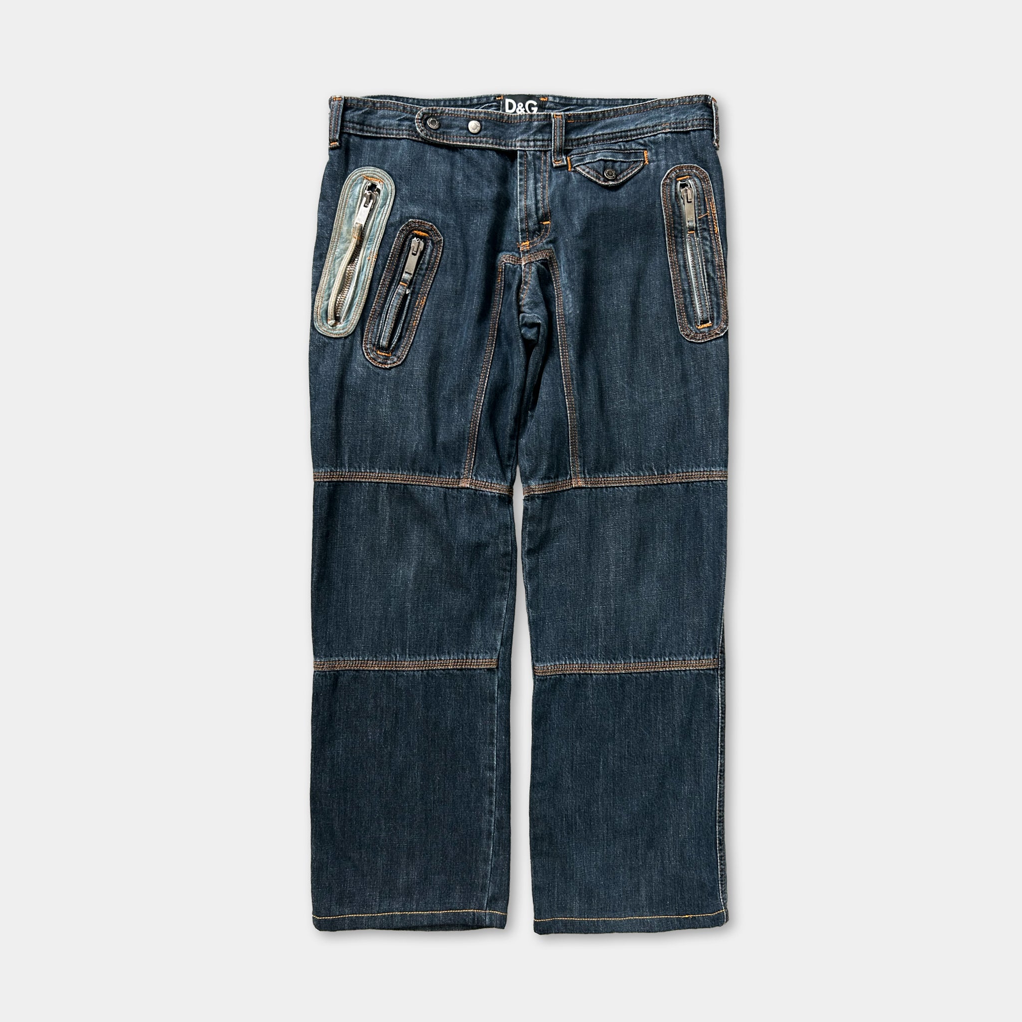 A pair of blue jeans with multiple pockets and zippers.