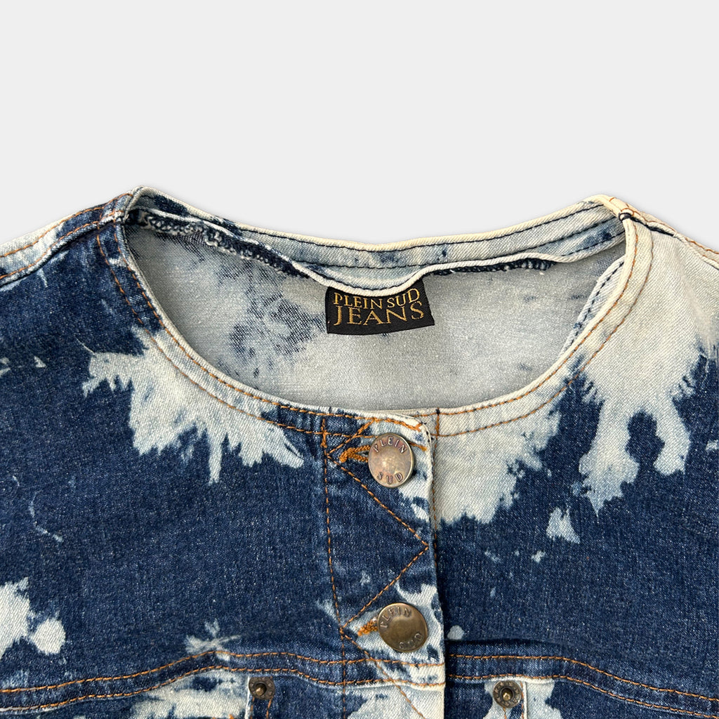 A close-up view of a denim jacket with a label that reads "PENNY SUB JEANS" on the collar.