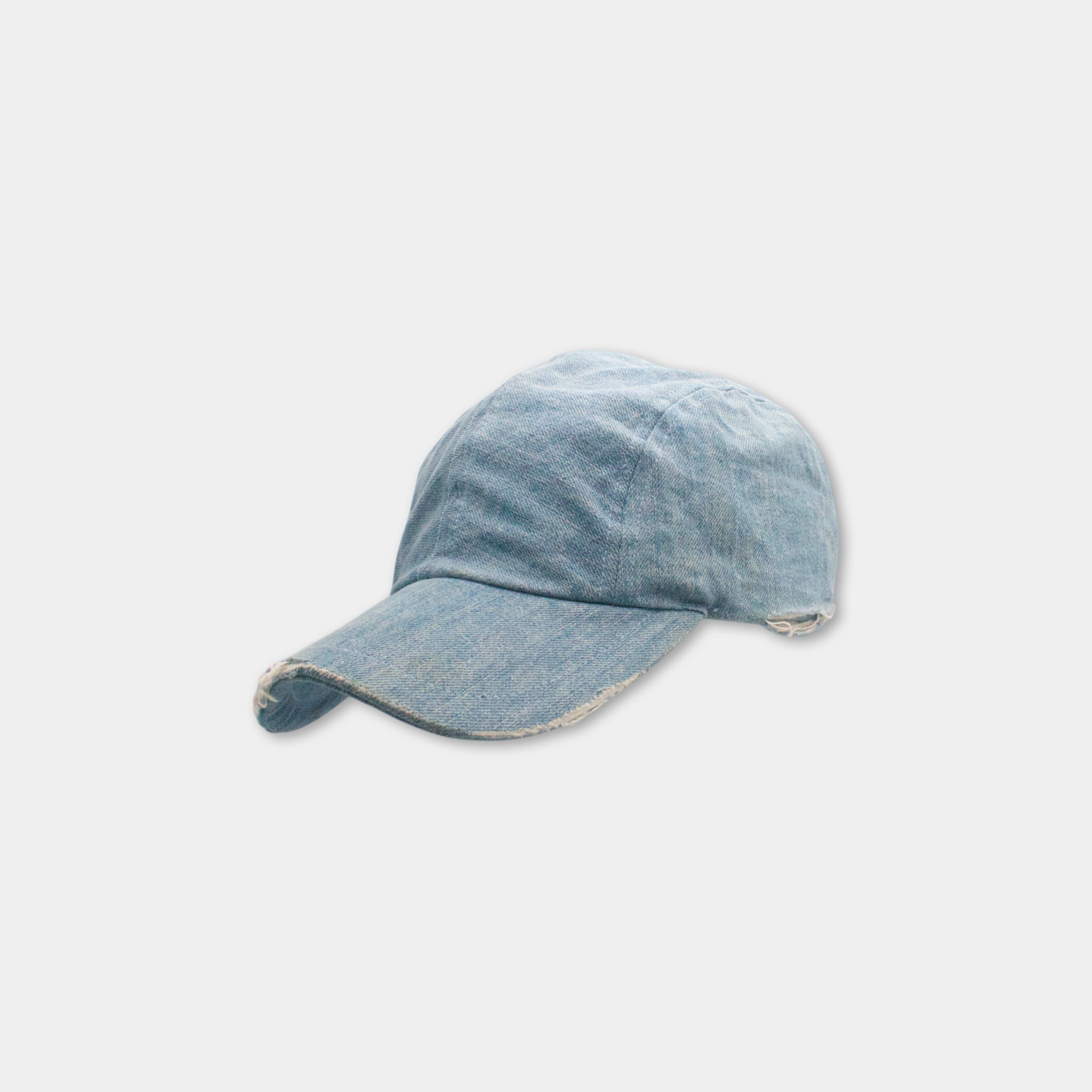 A blue denim baseball cap is shown against a plain white background.