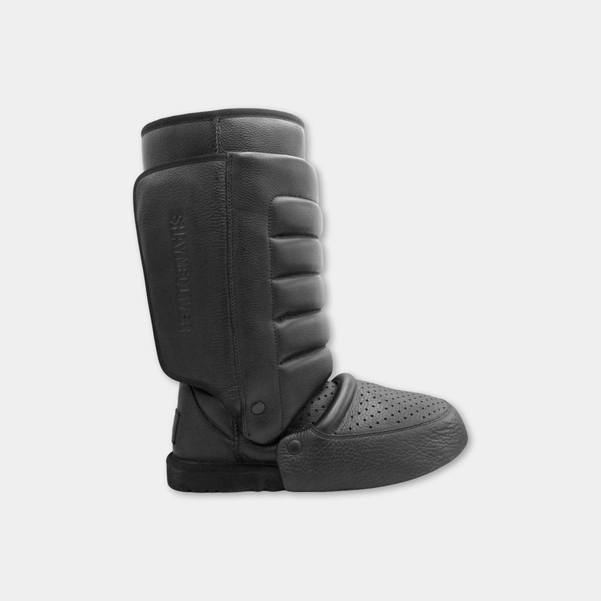 A pair of black leather boots with a textured sole and a textured upper.