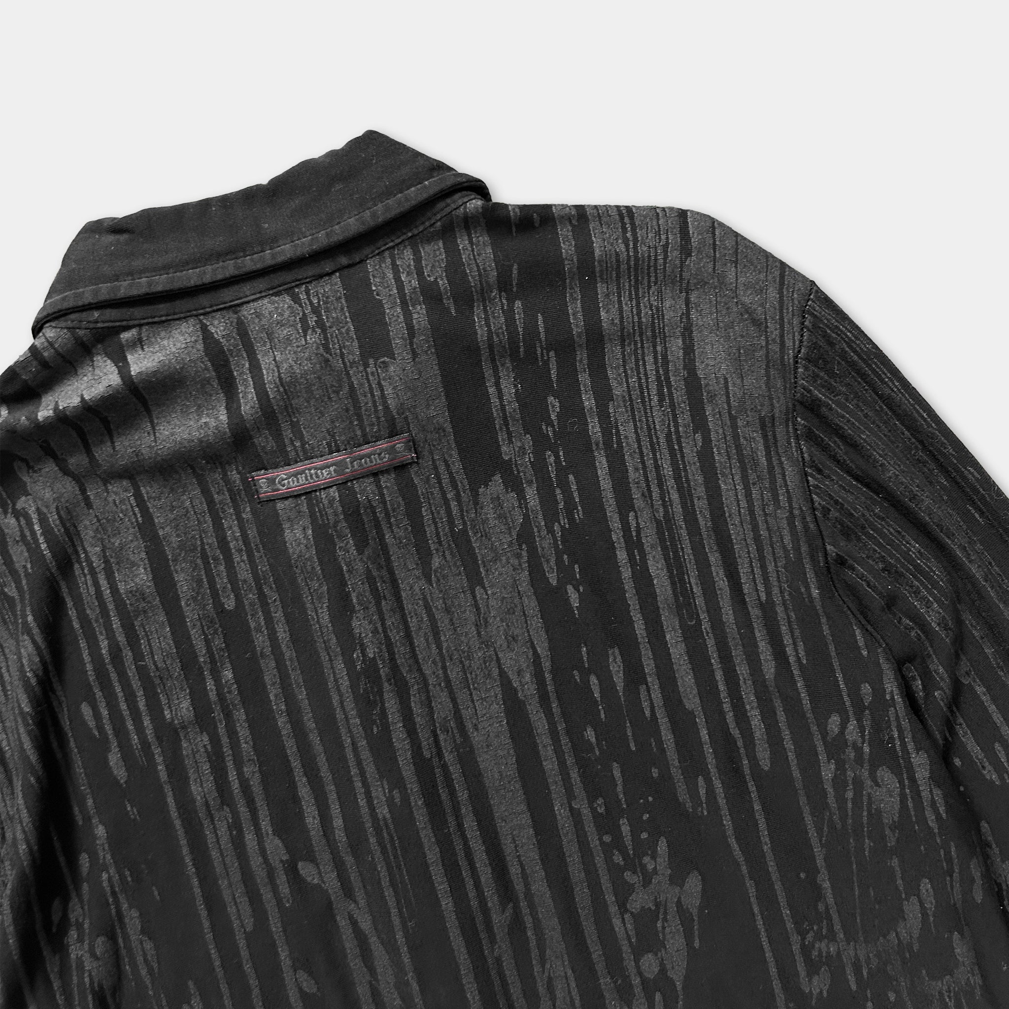 a close-up view of the back of a black jacket with a distinctive textured pattern.