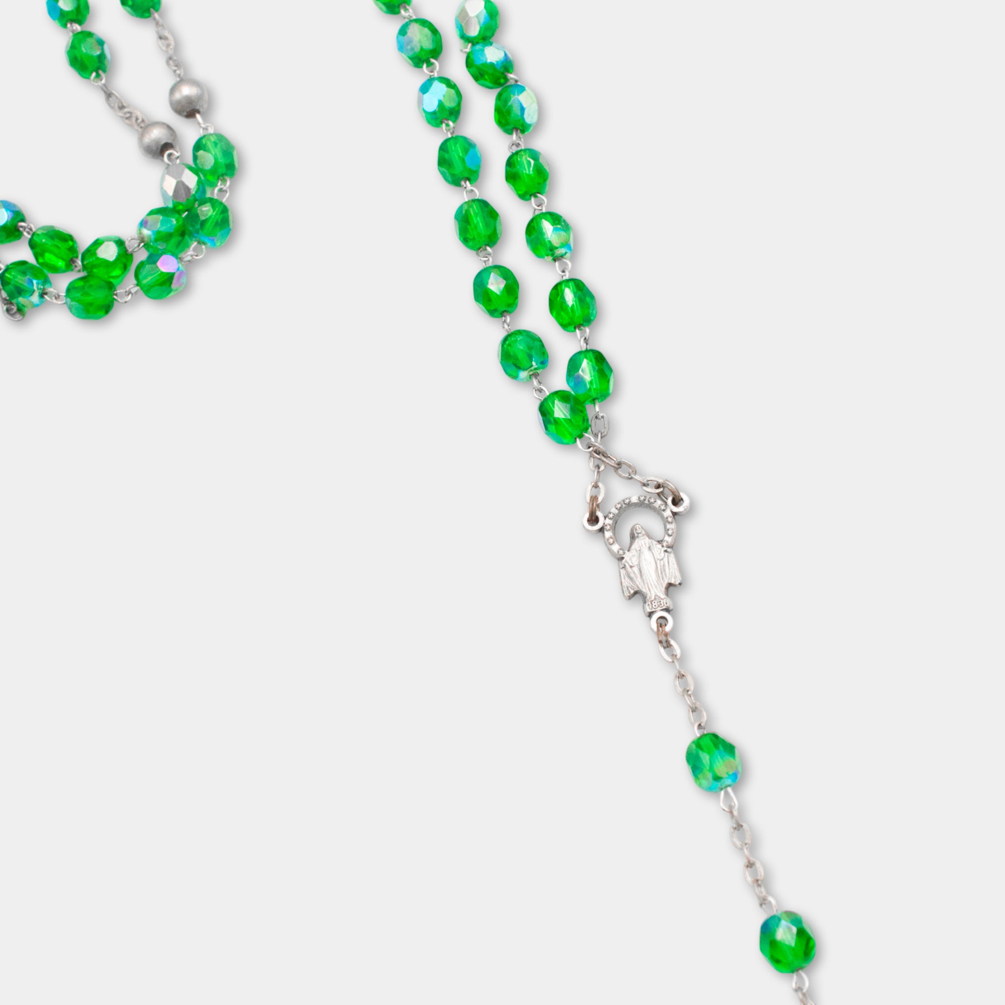 A necklace with green glass beads and a silver clasp.