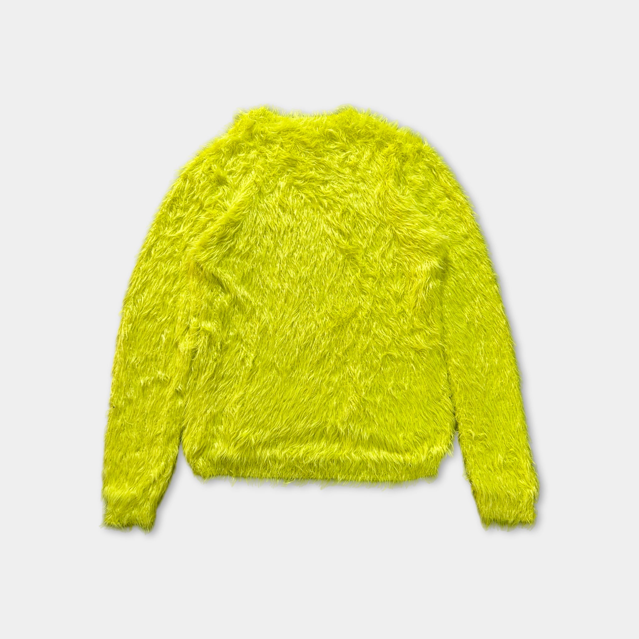 A bright yellow, furry sweater is shown against a white background.