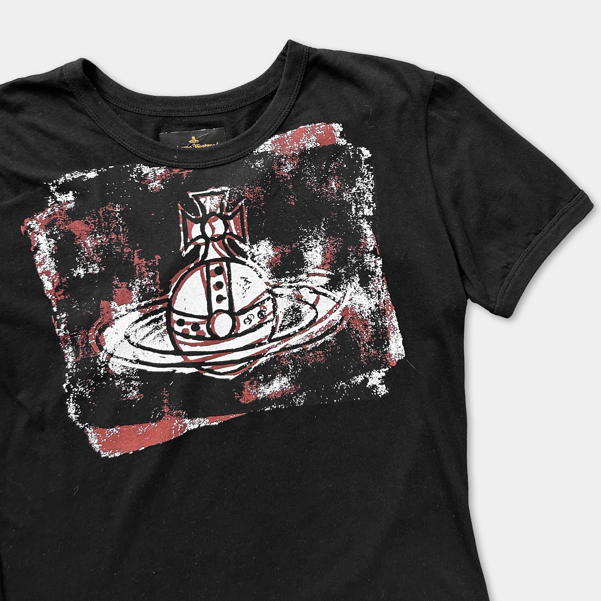 A black t-shirt with a graphic design featuring a stylized image of a ship or submarine.