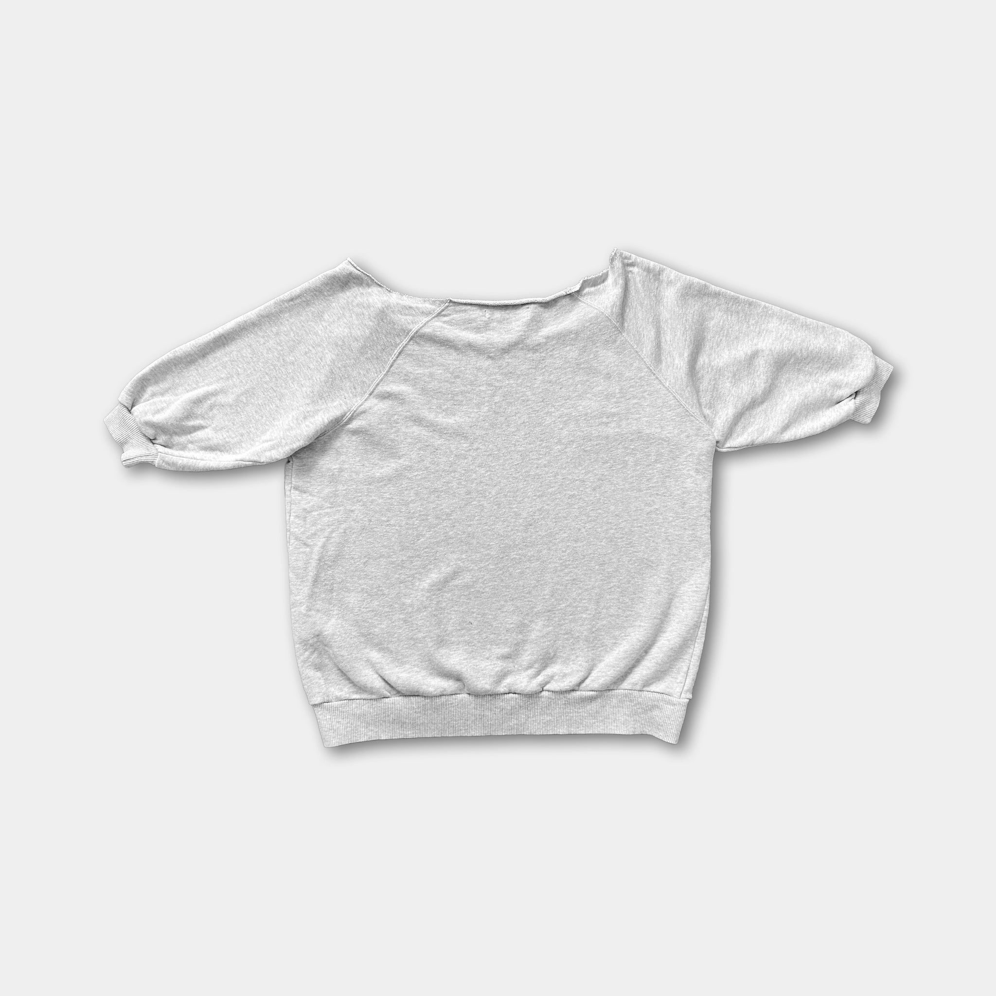 A plain white sweatshirt with puffed sleeves is shown against a white background.