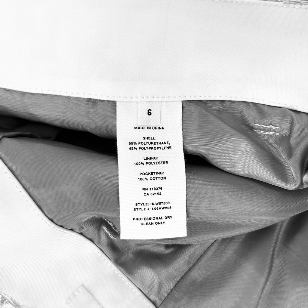 a close-up view of a label on a piece of clothing, likely a pair of pants or a jacket, with a focus on the details and information provided on the label.
