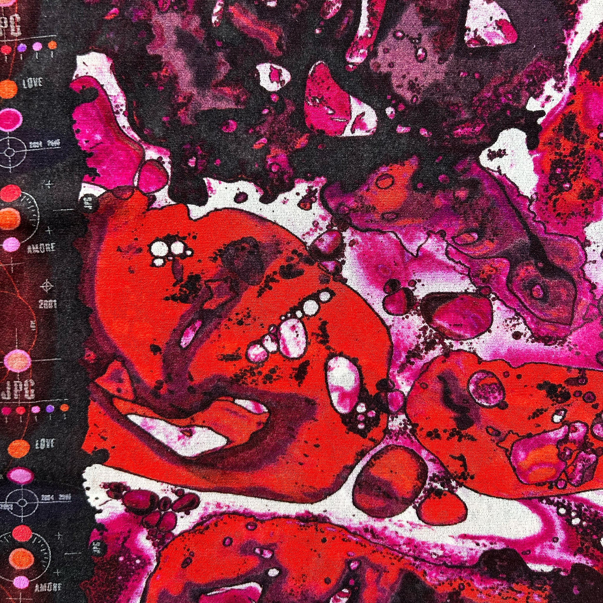 The image is a vibrant abstract painting with bold, overlapping shapes in shades of red, pink, and black. The painting features a mix of organic and geometric forms, creating a dynamic and visually striking composition.