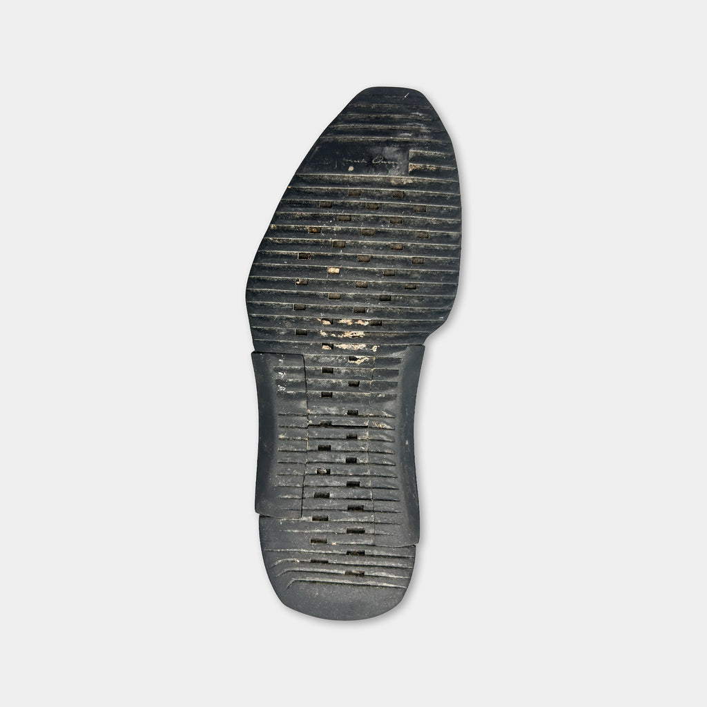 A black sole of a shoe against a white background.