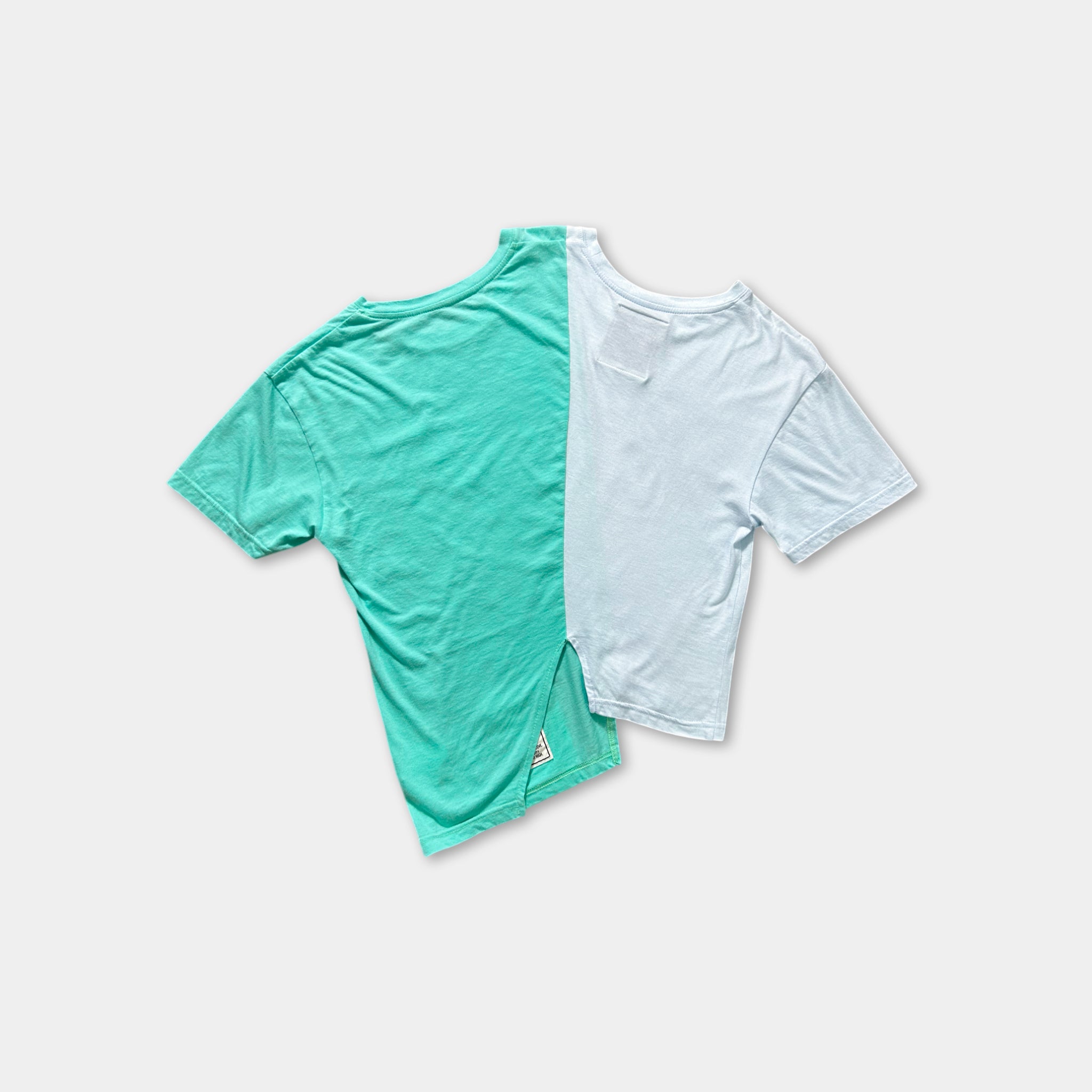 two t-shirts, one in teal and one in white, laid out against a plain white background.