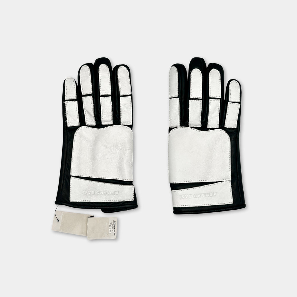 A pair of black and white gloves with white palm patches, placed side by side against a white background.