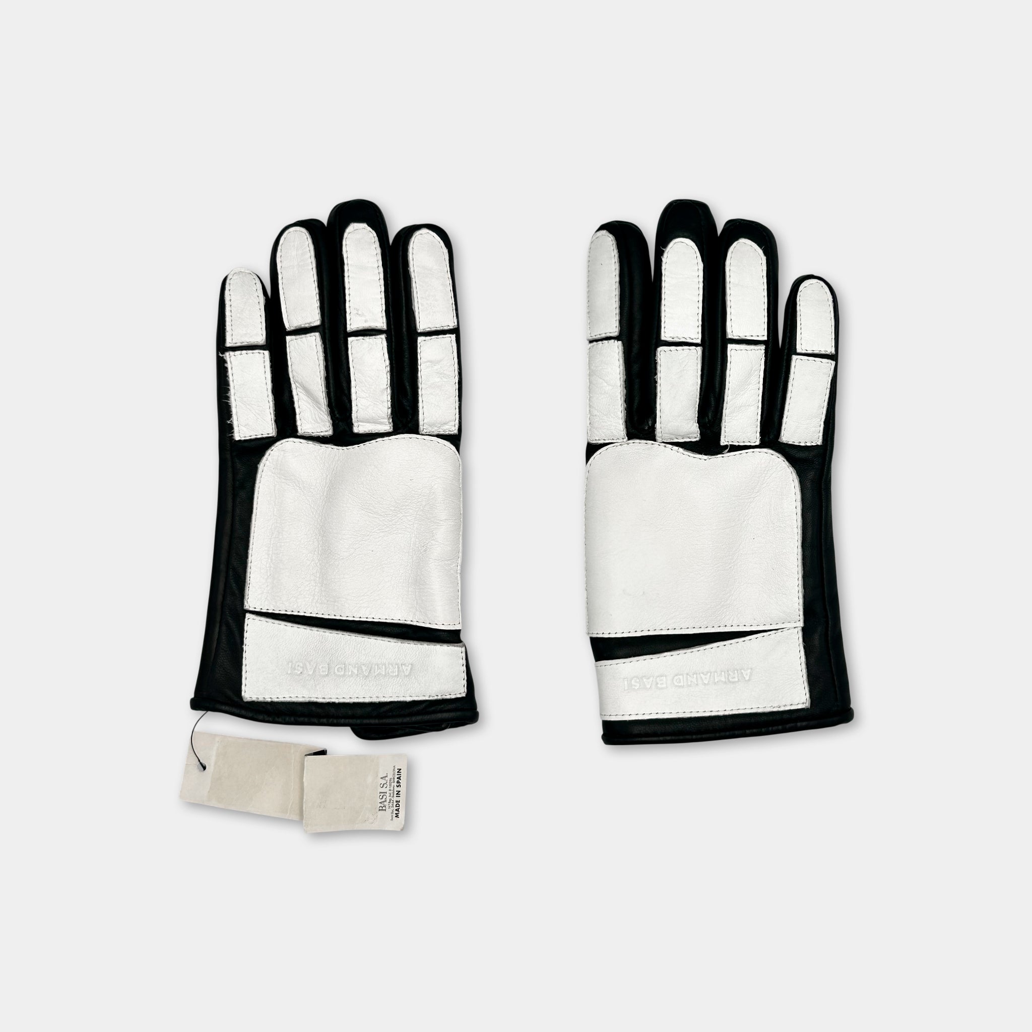 A pair of black and white gloves with white palm patches, placed side by side against a white background.