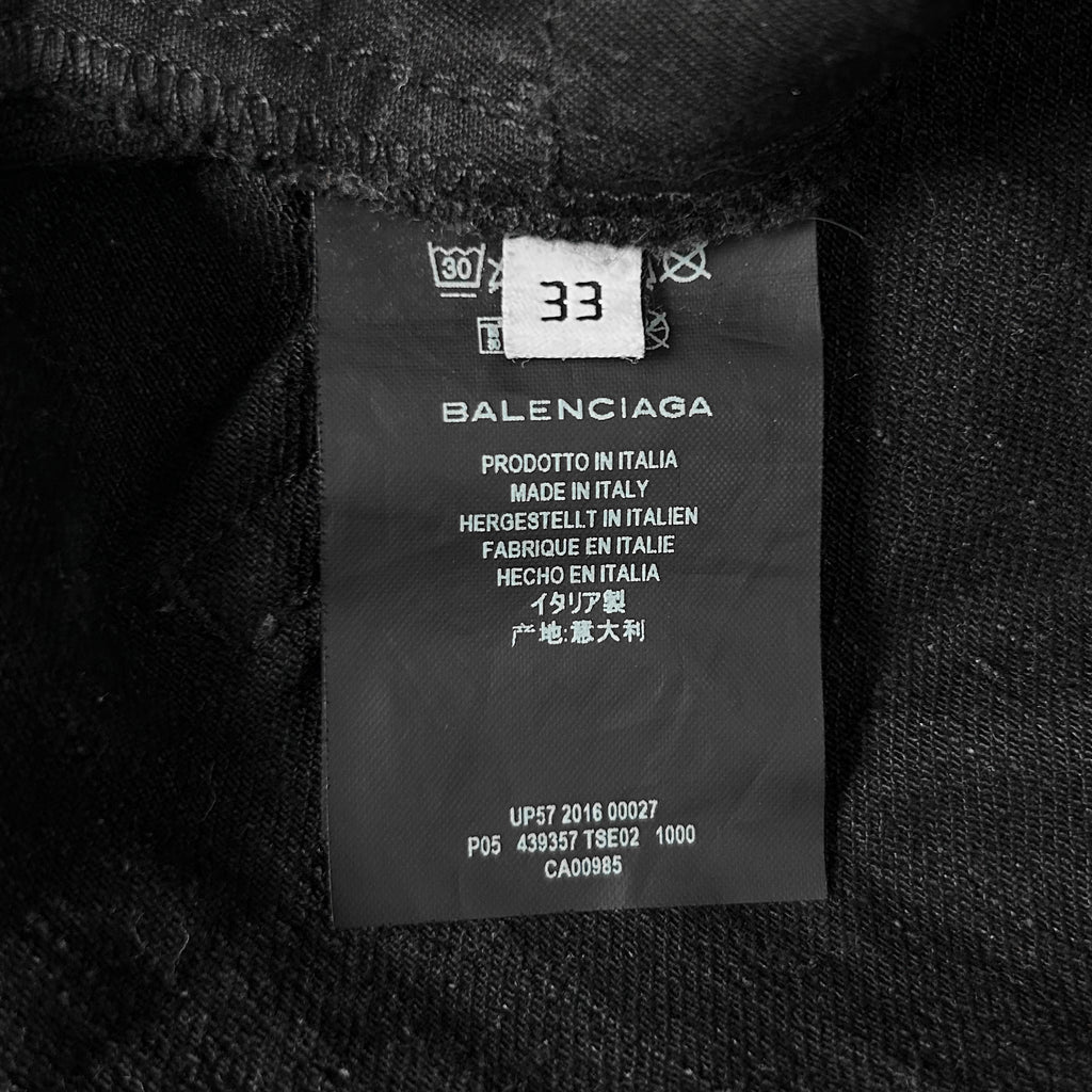 a close-up view of a black fabric label with text and numbers, likely indicating the brand and production details of the fabric.