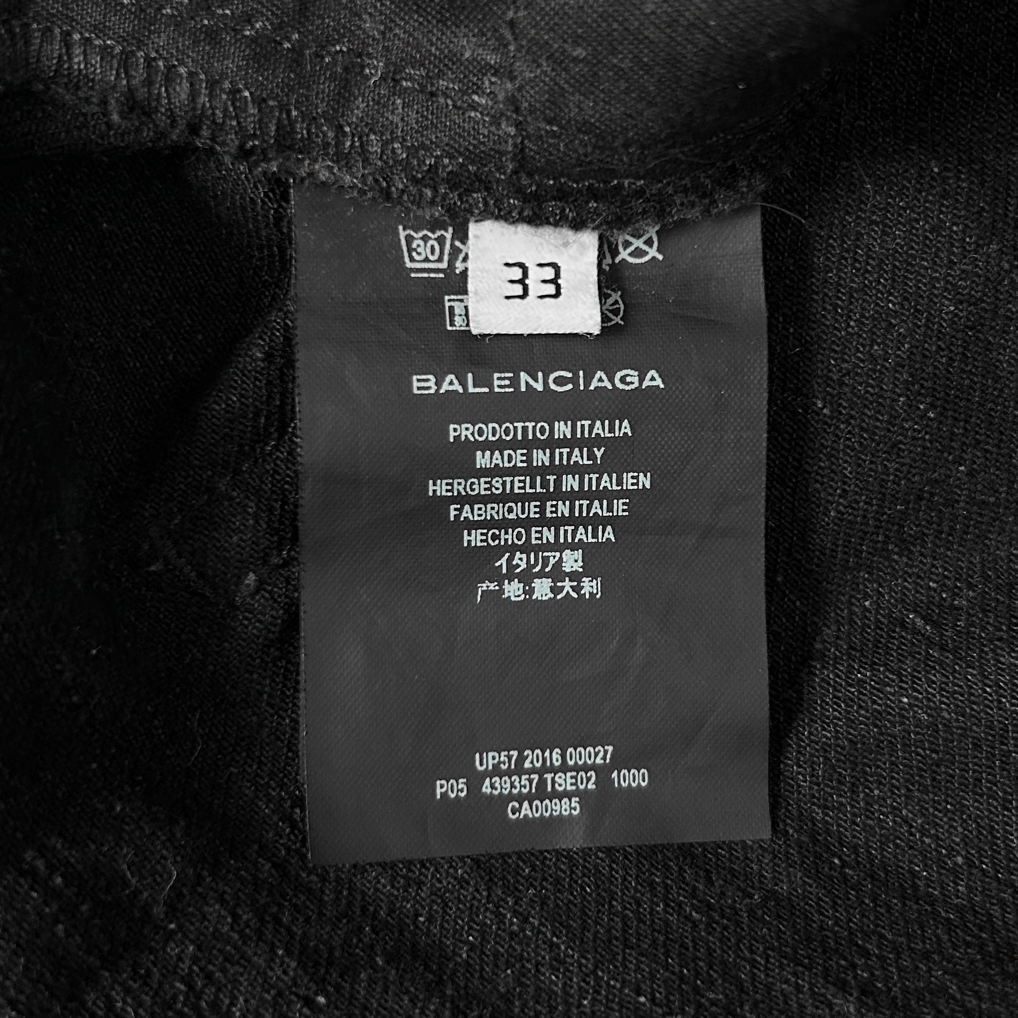 a close-up view of a black fabric label with text and numbers, likely indicating the brand and production details of the fabric.