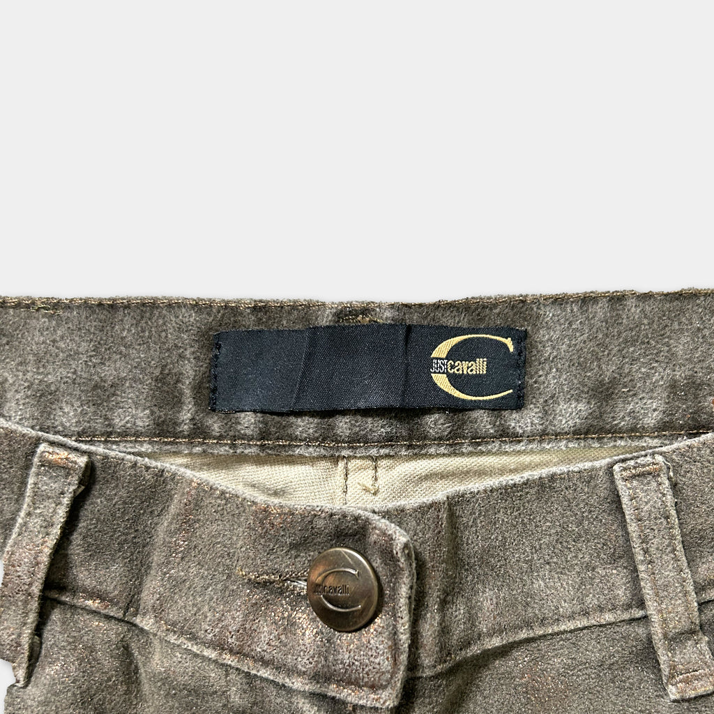 A close-up view of a pair of gray jeans with a black label on the waistband.