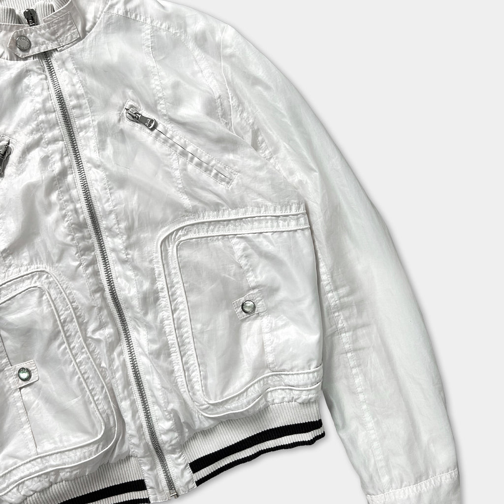 A white jacket with multiple pockets and zippers.