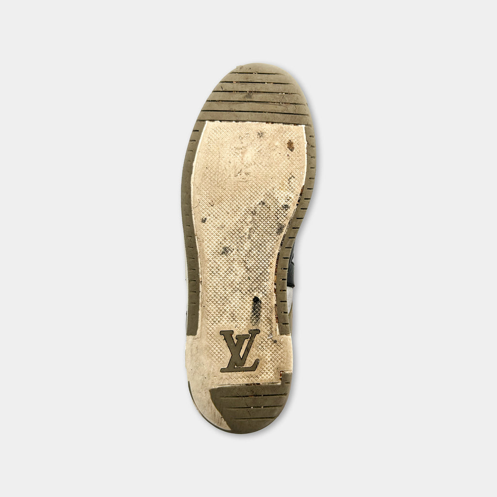 A worn and dirty shoe sole with a logo on it.