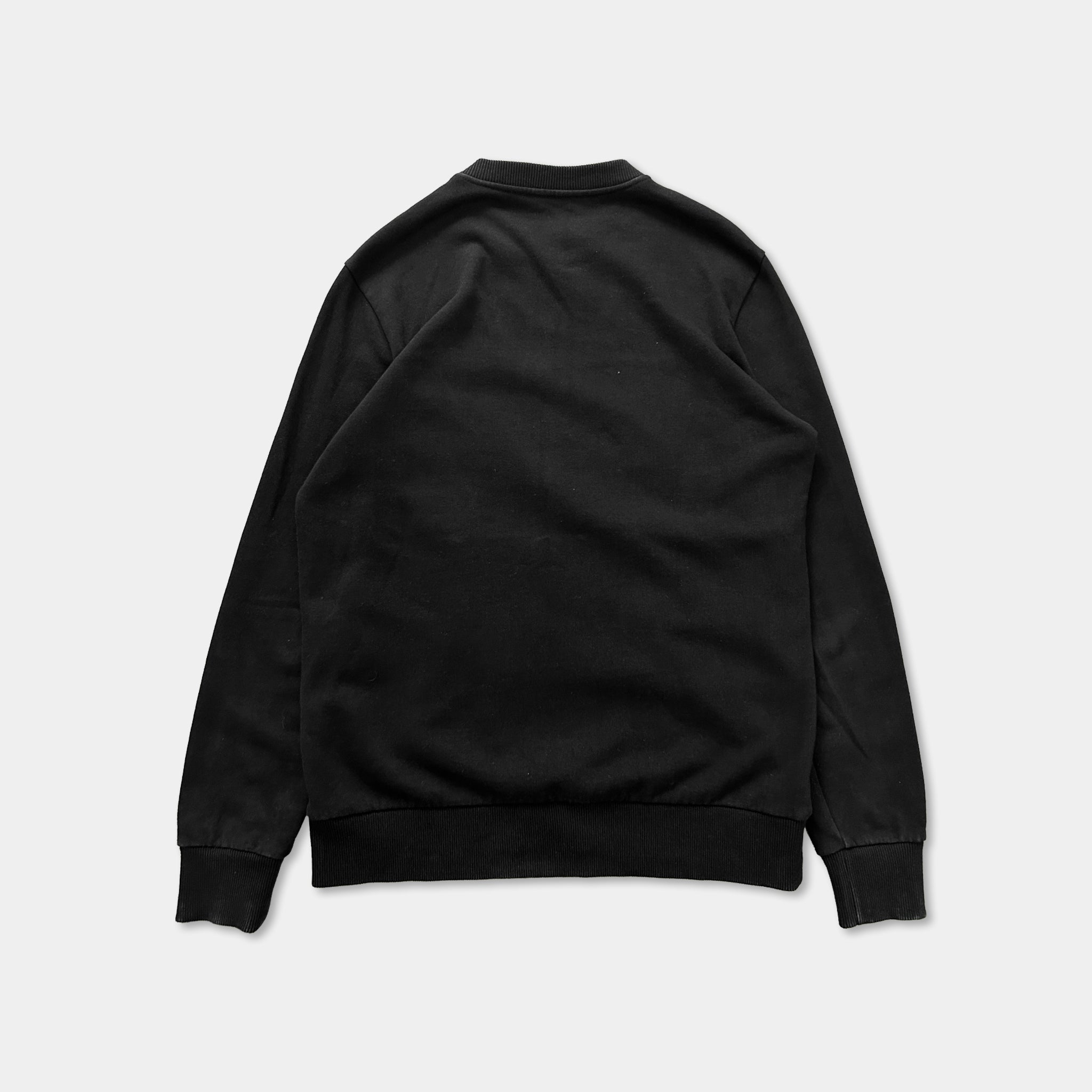 A black long-sleeved shirt is shown against a white background.