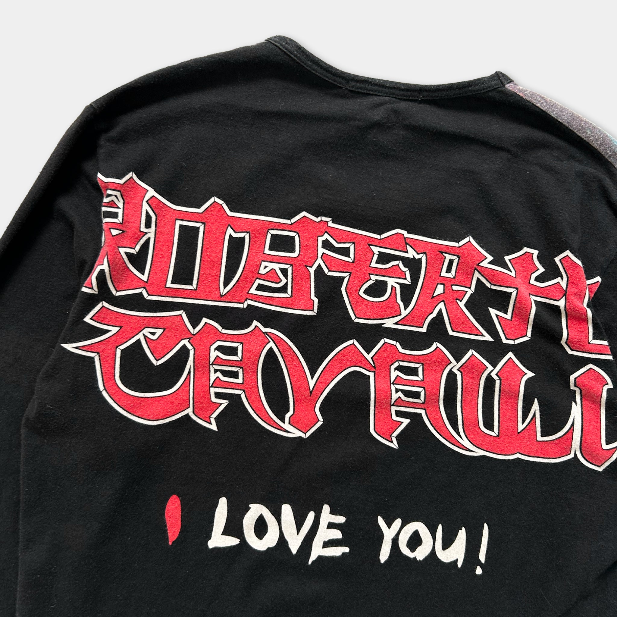 A black long-sleeved t-shirt with red and white text and graphics on the back.