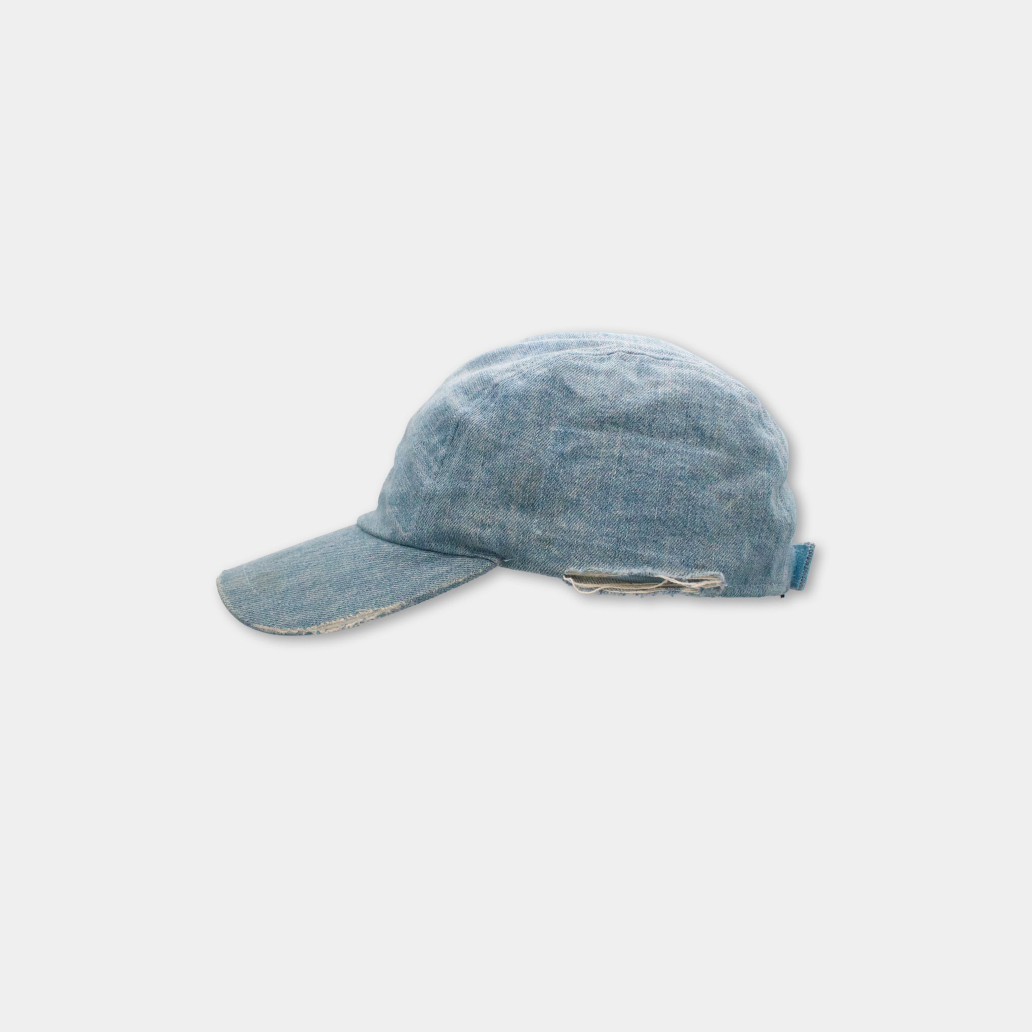 A blue denim baseball cap is shown against a white background.