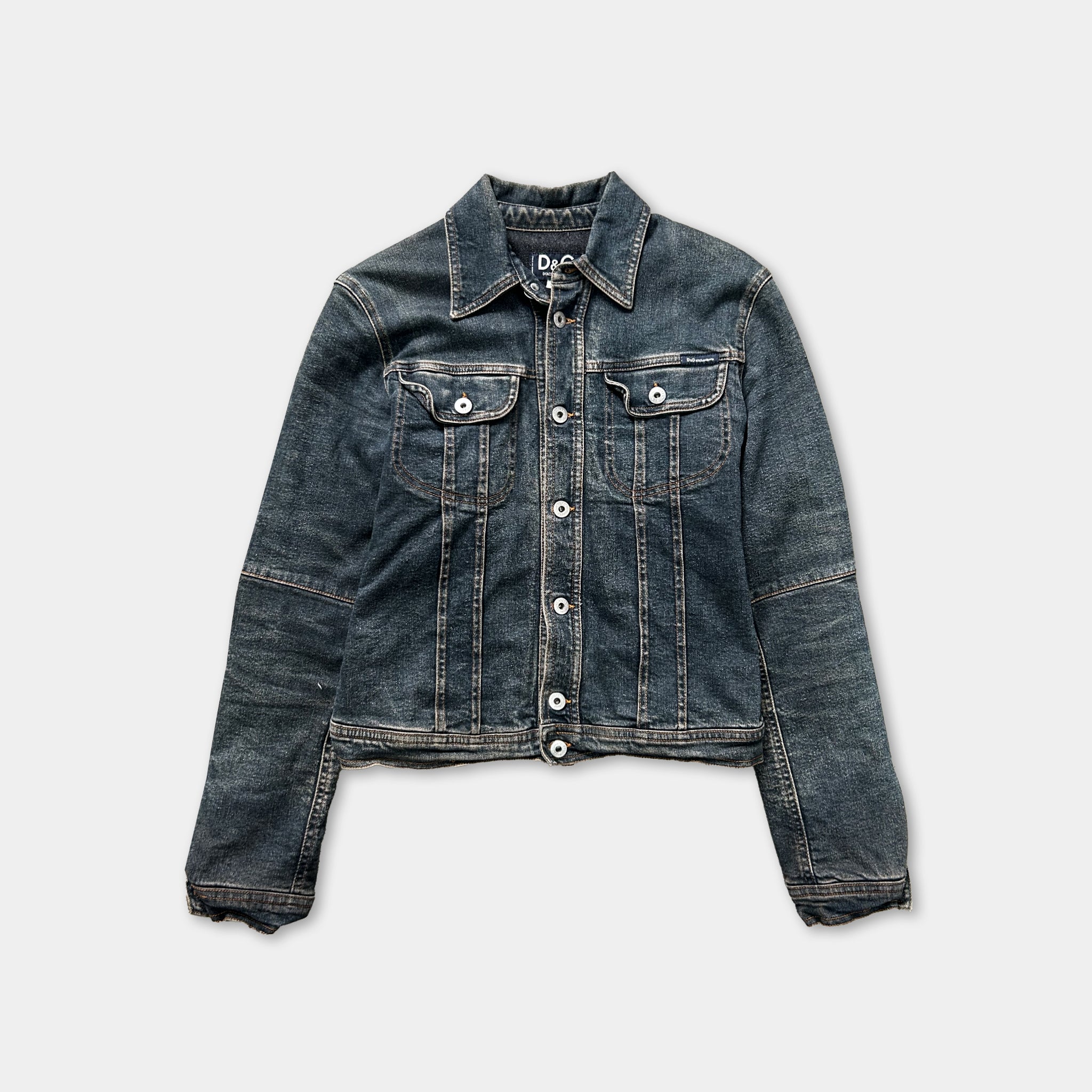 A dark blue denim jacket with a button-down front and long sleeves, displayed against a white background.