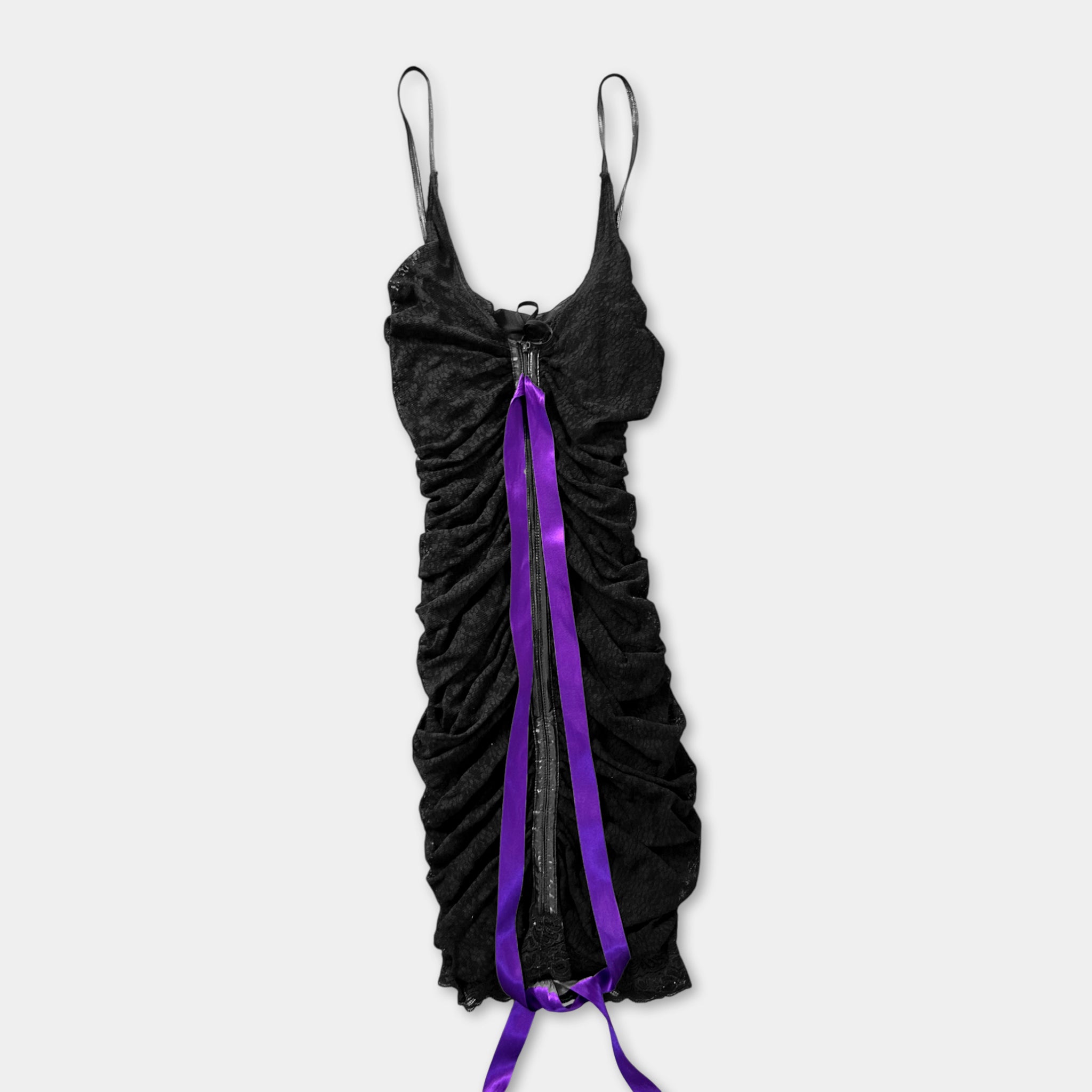 A black dress with a purple ribbon tied into a bow at the waist.