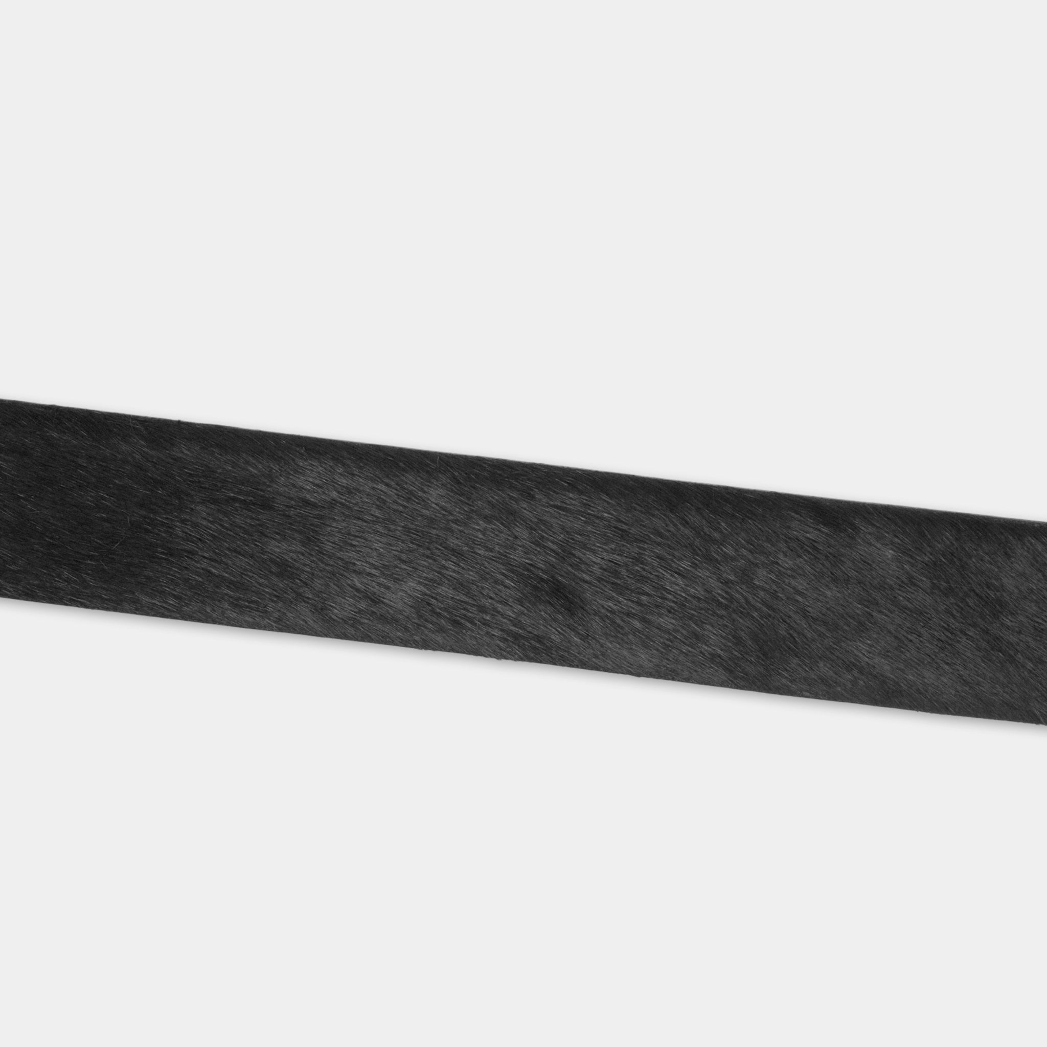 A close-up view of a black, textured surface, possibly a piece of fabric or a material with a similar appearance.