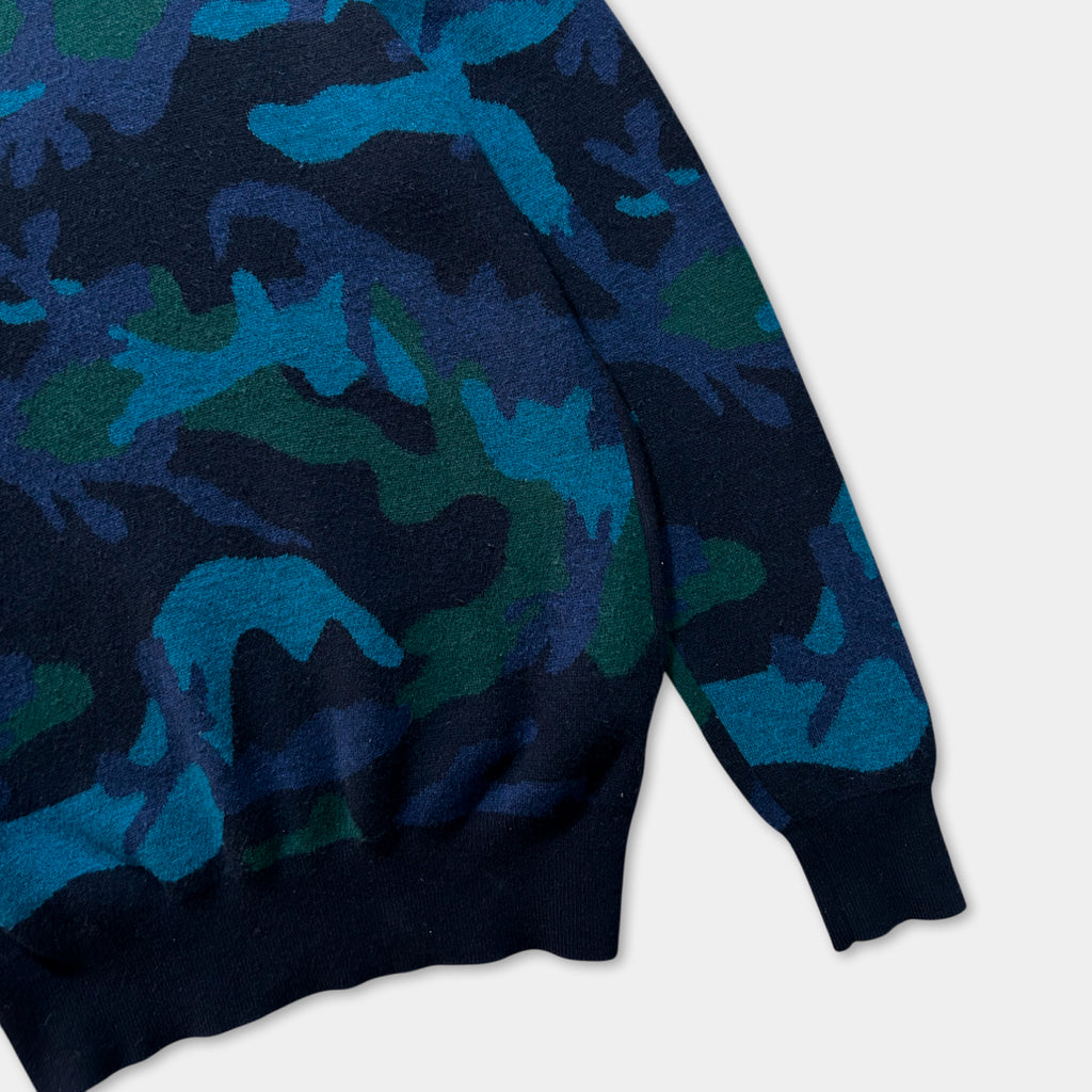 A close-up view of a blue and green camouflage patterned sweater.