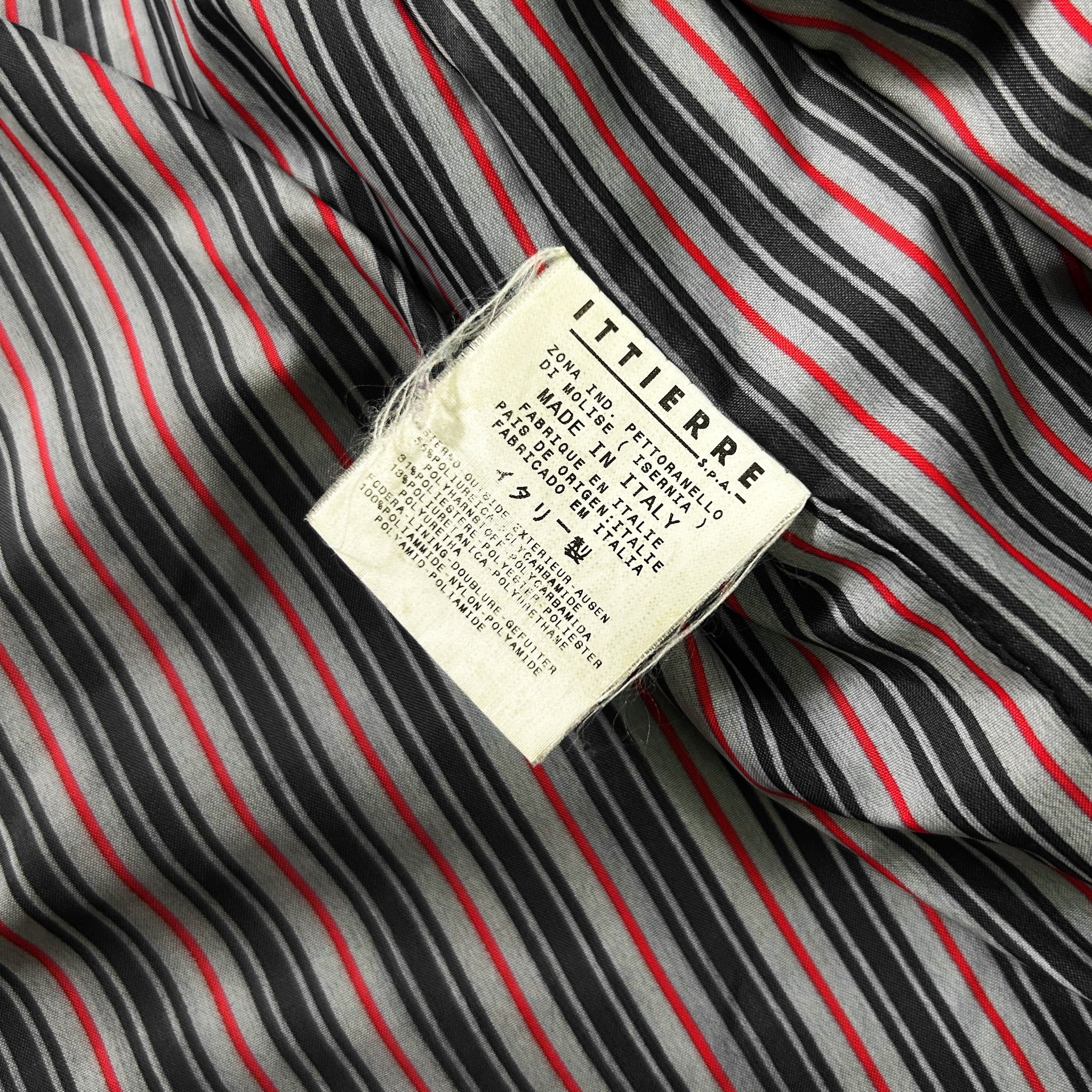 a close-up view of a fabric with a label attached to it, which appears to be a piece of clothing or textile.