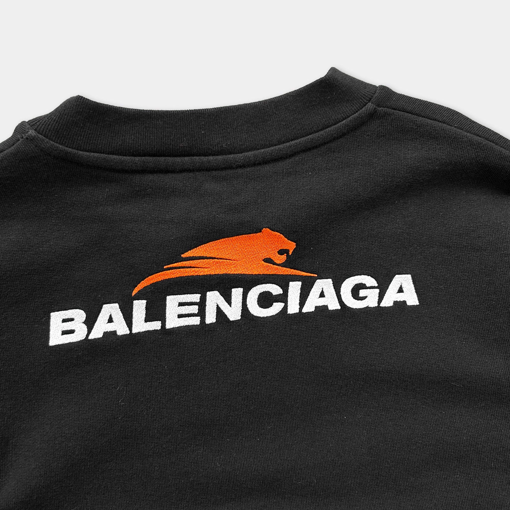 A black t-shirt with the Balenciaga logo printed on it.