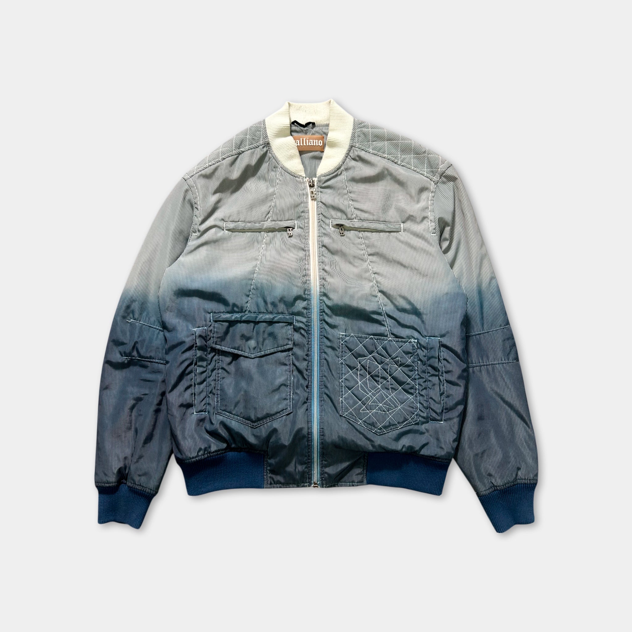 A gray and blue jacket with a white collar and zipper, featuring multiple pockets and a distinctive pattern.