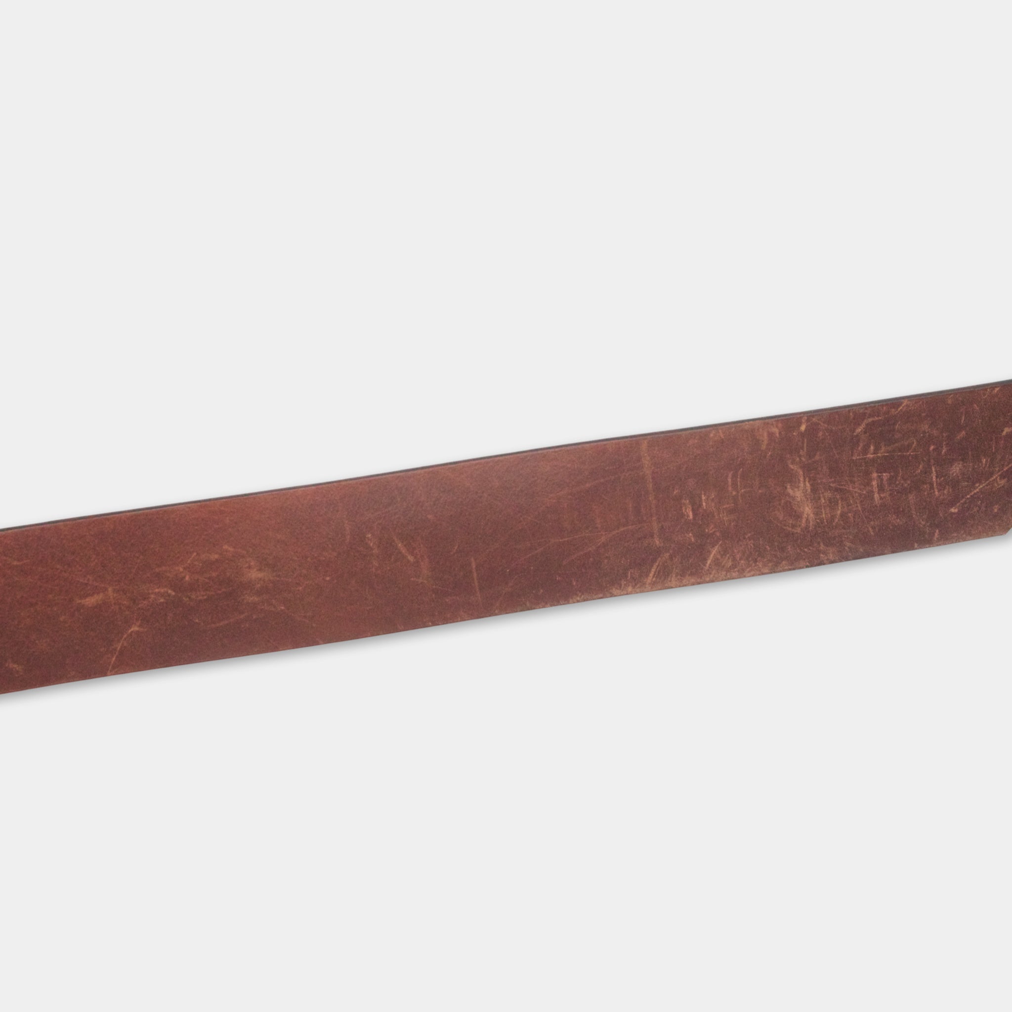 A long, brown leather belt is shown against a plain white background.