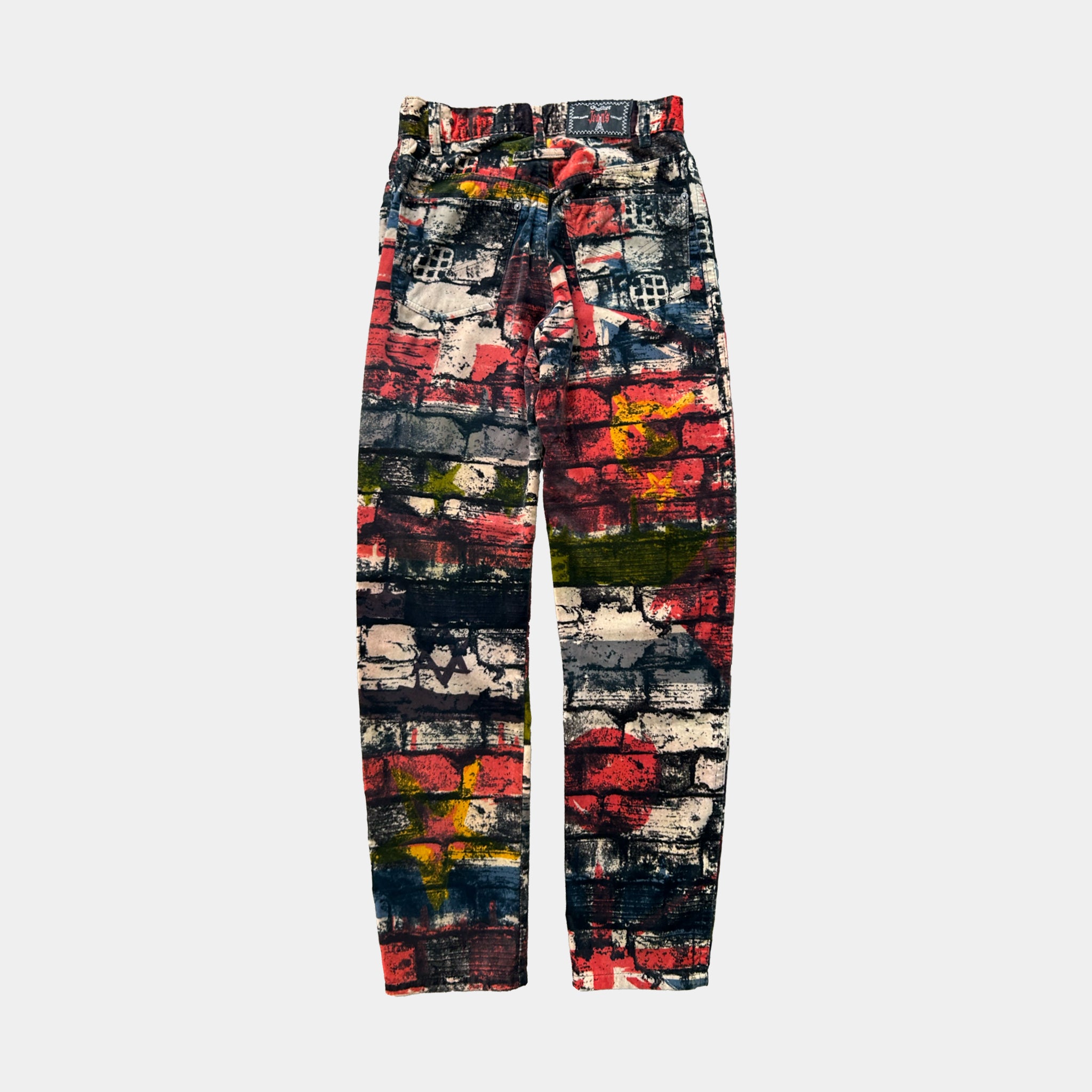 A pair of colorful, patterned pants with a brick or brick-like design.