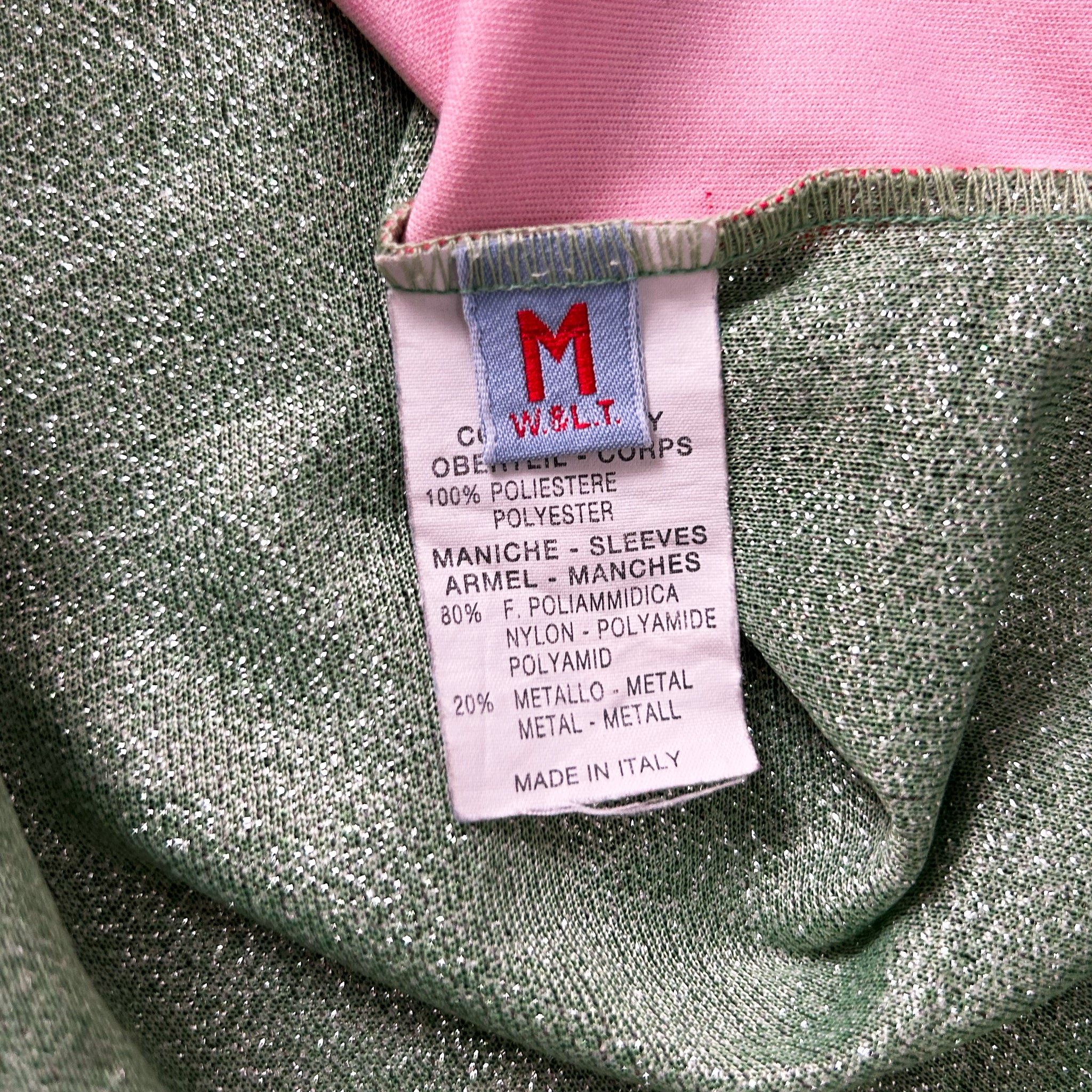 a close-up view of a fabric label with text, likely providing information about the material and manufacturing details of the garment.