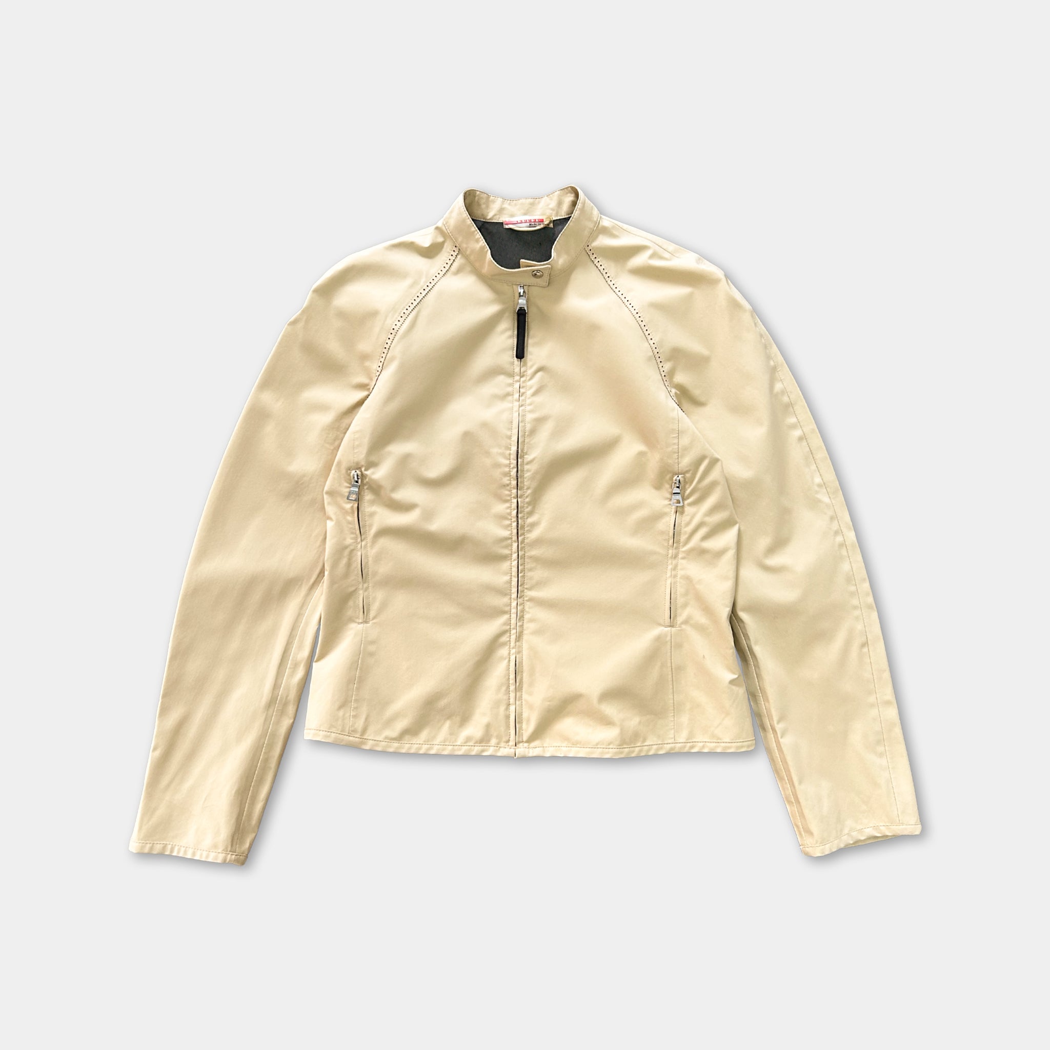 A beige jacket with a zipper and two pockets, displayed against a white background.