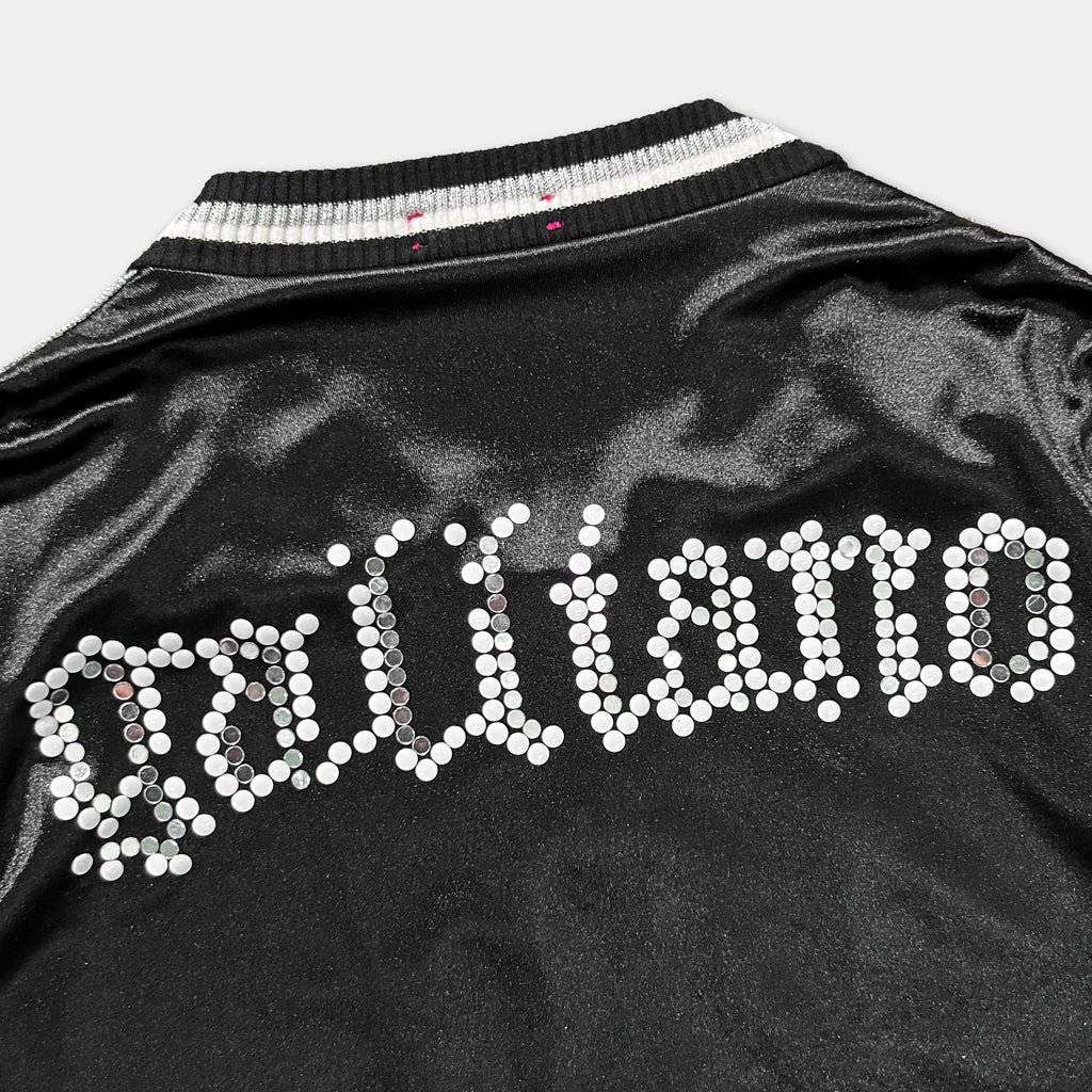 a close-up view of a black jacket with white dots arranged in a decorative pattern, covering the back of the jacket.