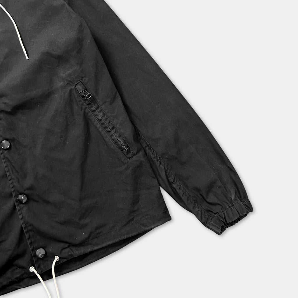 A black jacket with a zipper and drawstring is shown in the image.