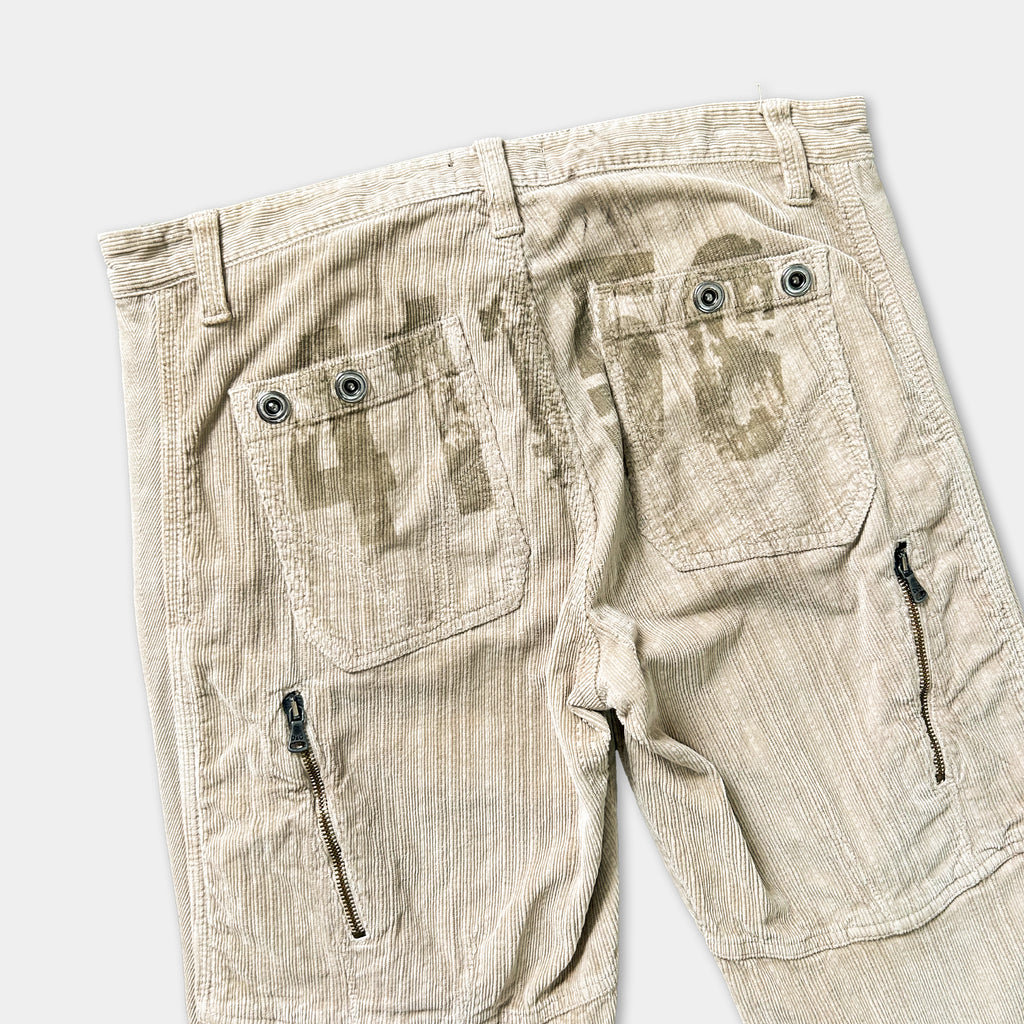 a pair of khaki cargo pants with a distinctive printed design on the pockets.