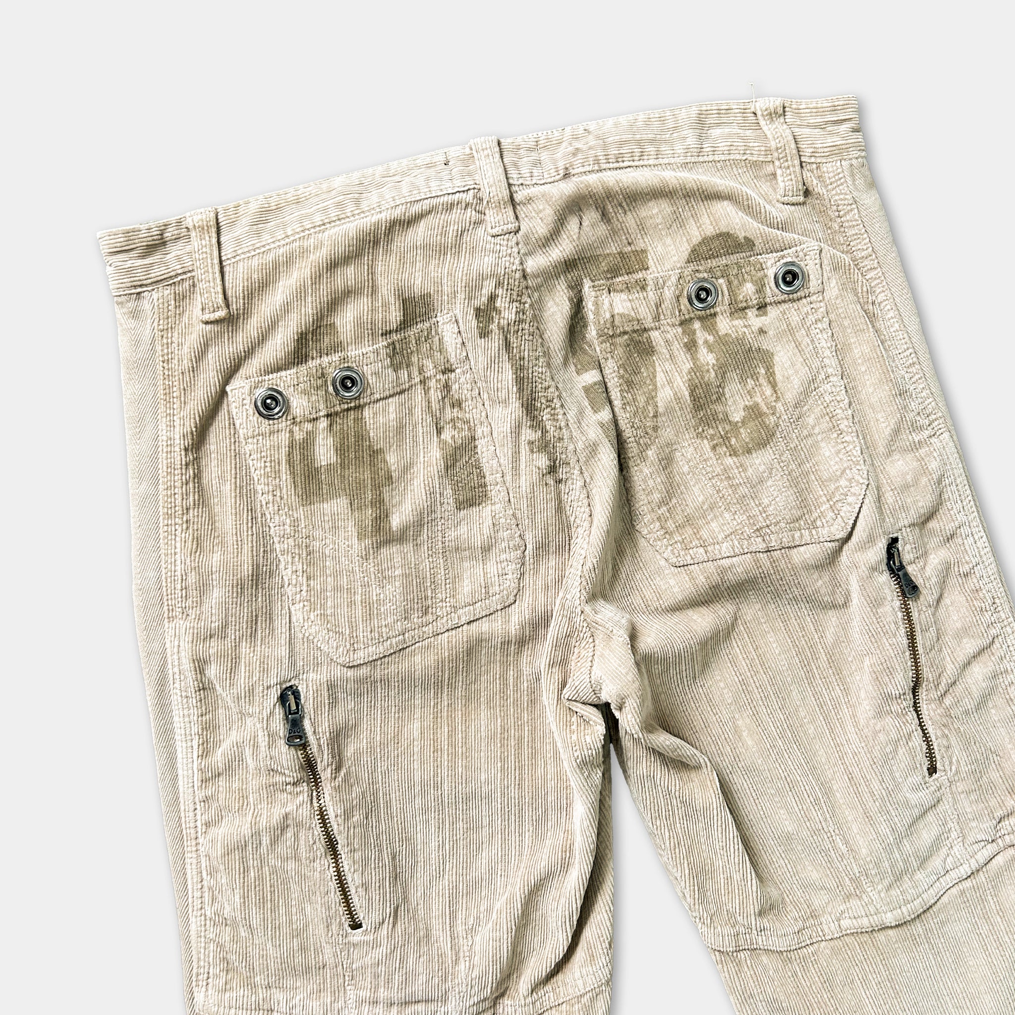 a pair of khaki cargo pants with a distinctive printed design on the pockets.