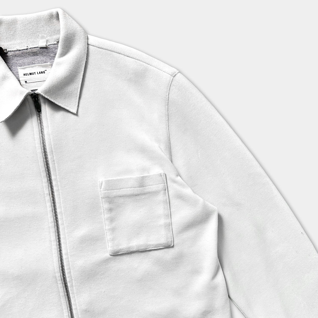 A white zip-up jacket with a collar and a pocket.