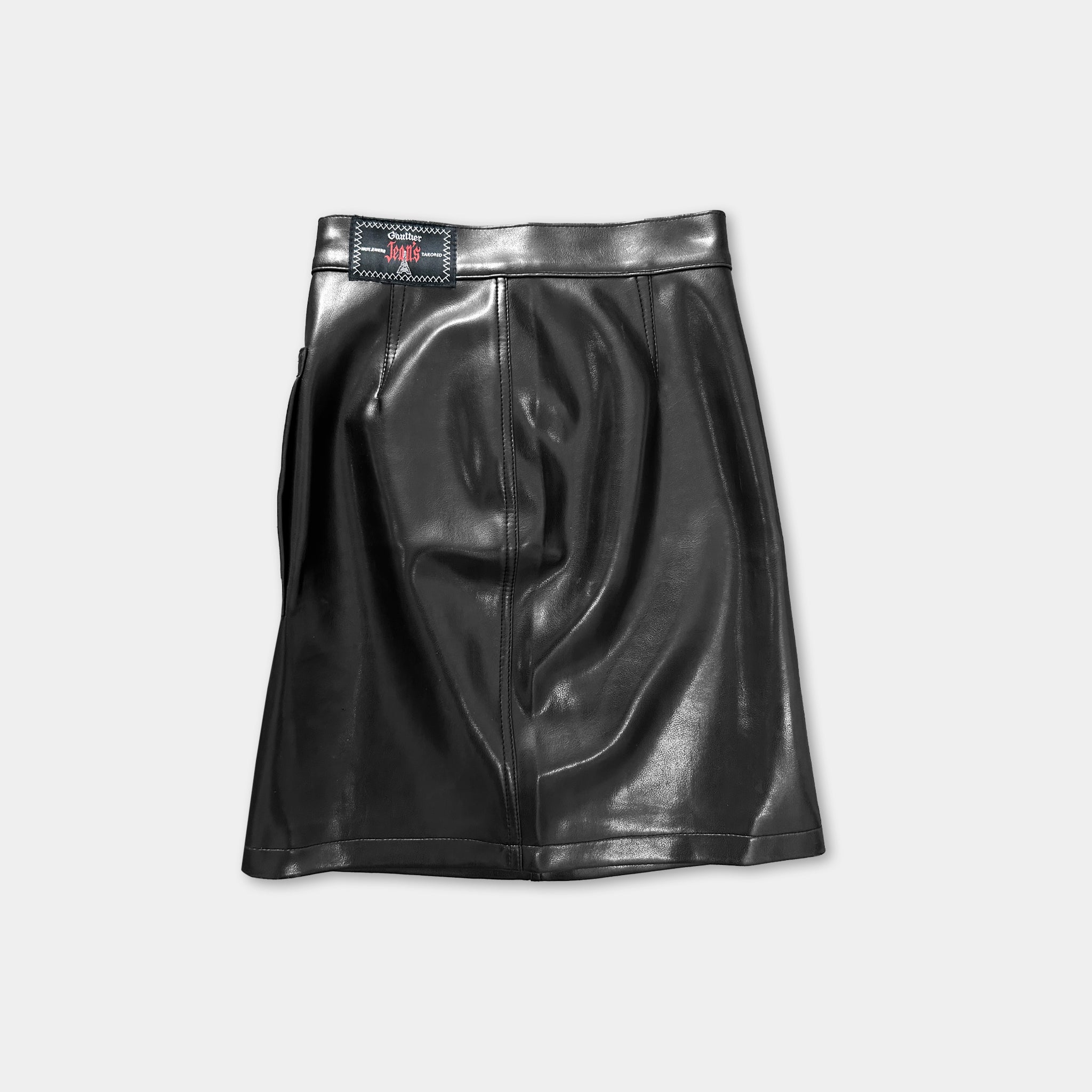 A black leather skirt with a small red logo on the waistband.
