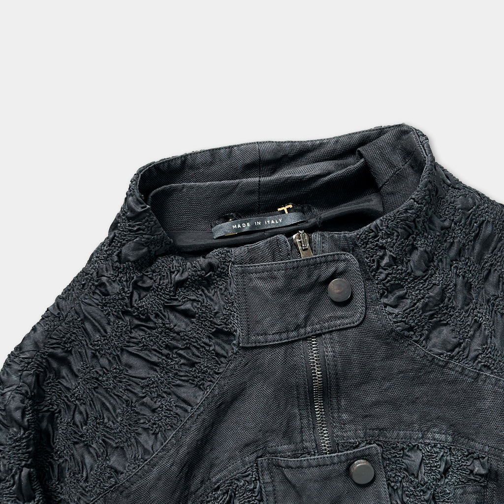 A close-up view of a black jacket with a label that reads "MADE IN ITALY".