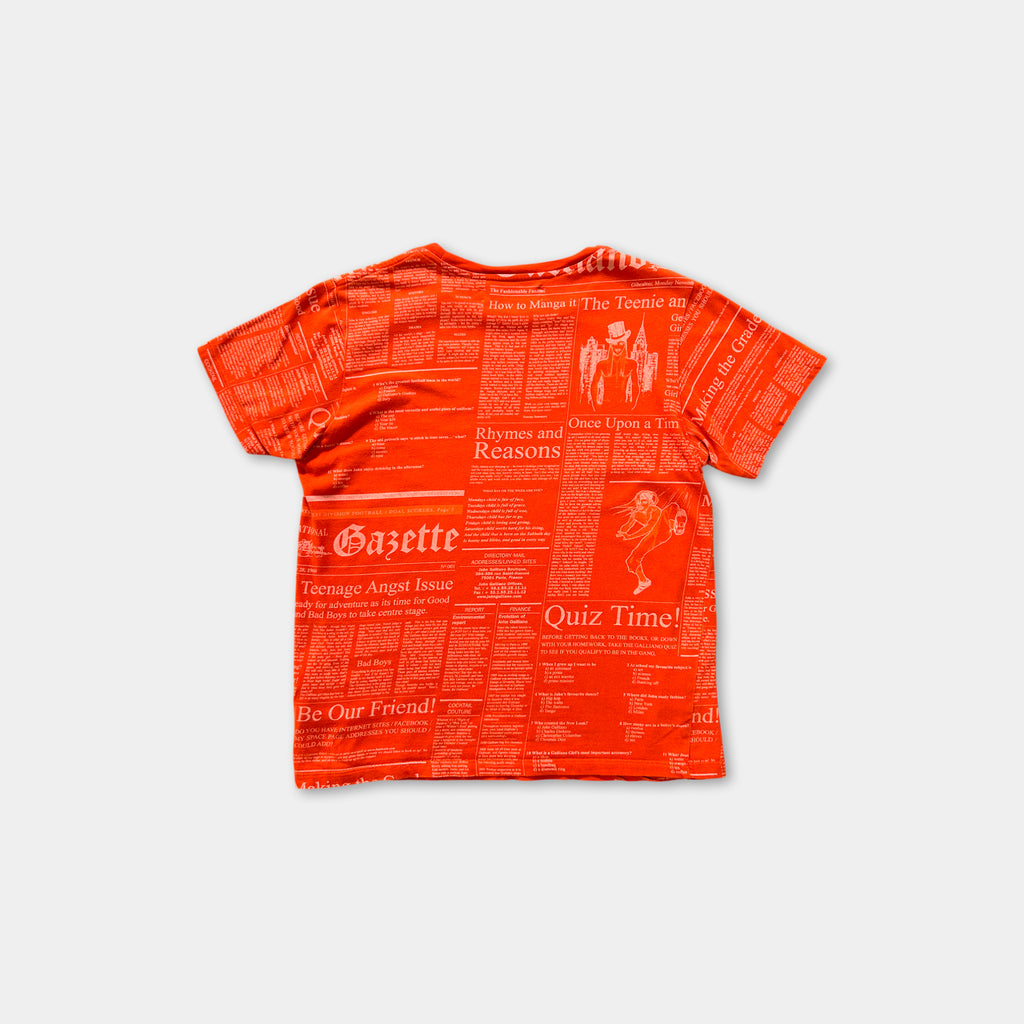 The image is a red t-shirt with a newspaper-style print on it.