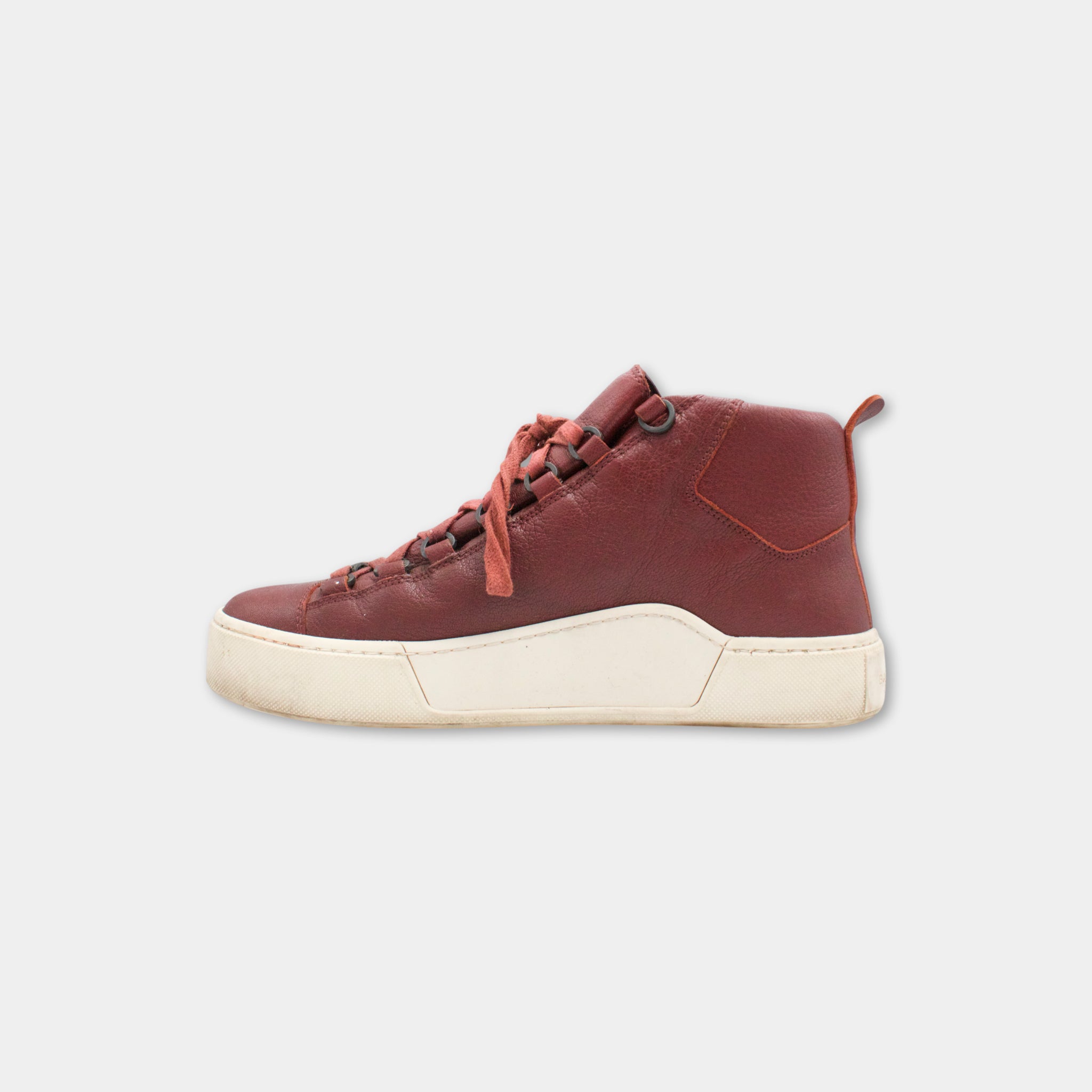 A single red high-top sneaker with a white sole, shown against a plain white background.