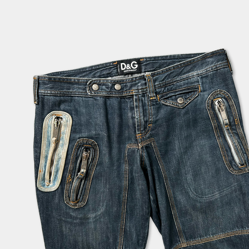A pair of blue denim jeans with multiple zippers and pockets, including a zipper pull and a zipper pull with a zipper pull.